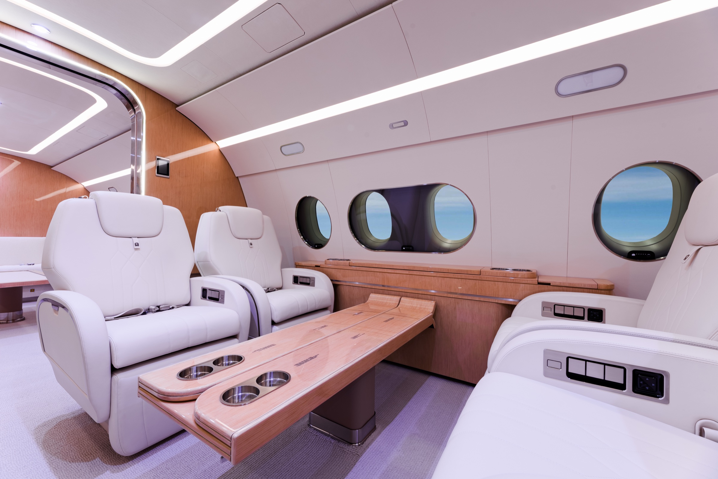 ACJ220 club seating, cabin windows, and bespoke wood tables