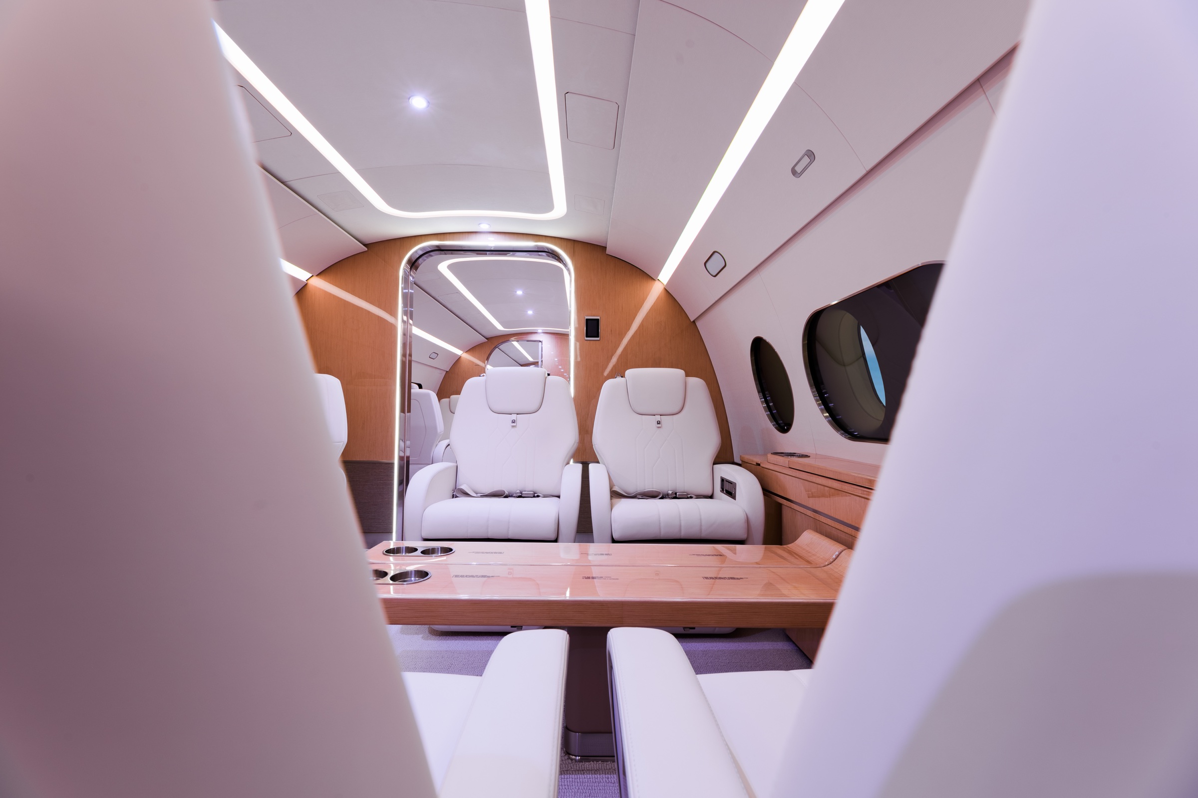 ACJ220 cabin seating framed through the sculpted interior