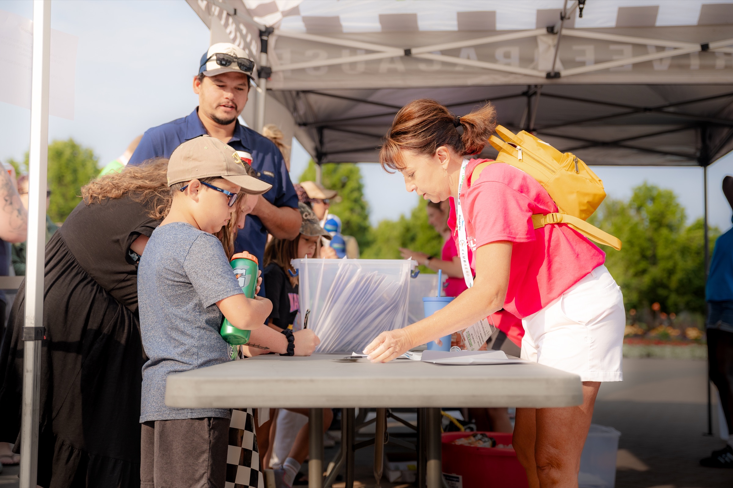 Dream Rally volunteers welcoming a young participant at registration