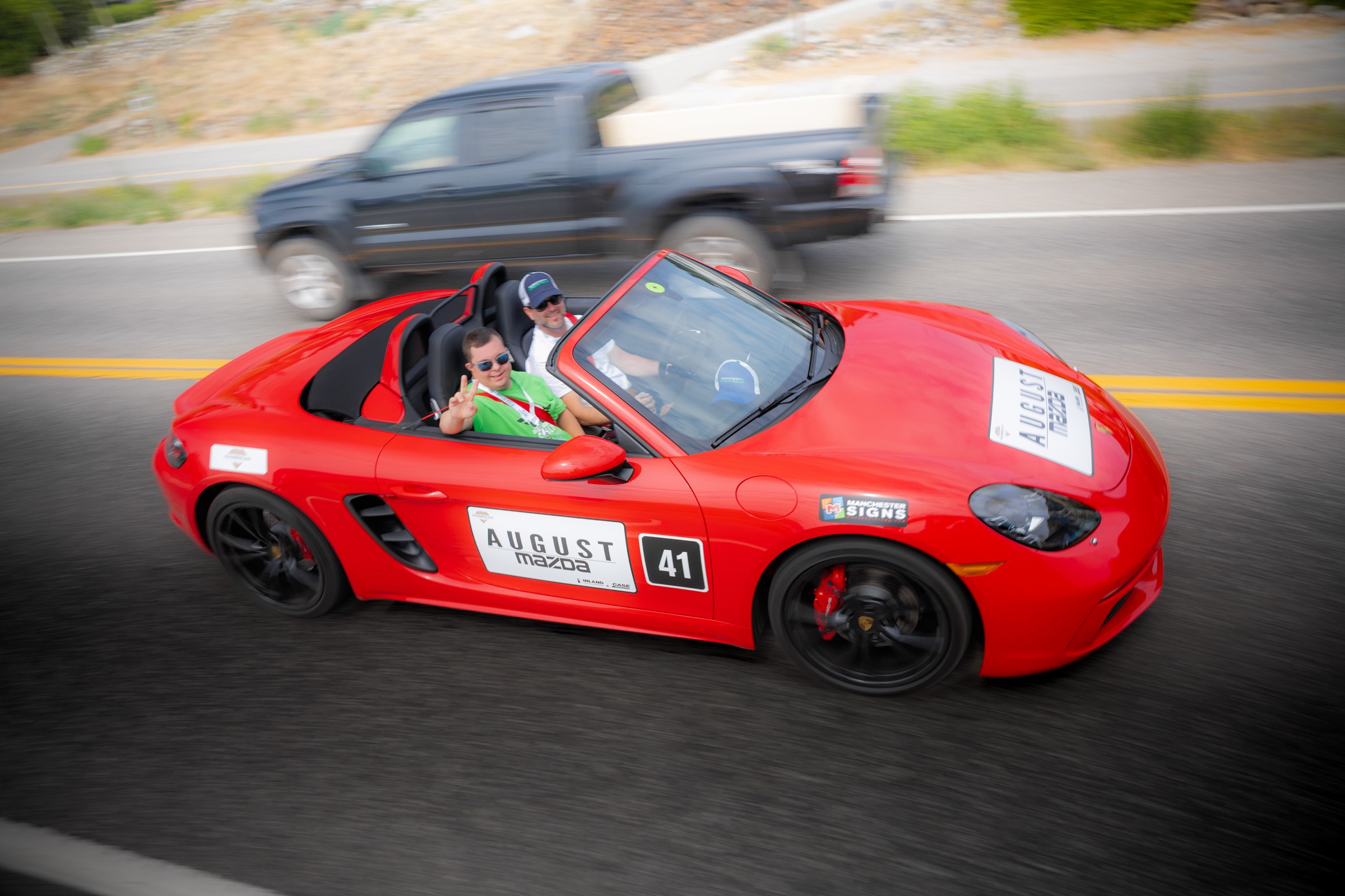 Red Porsche Boxster carrying a Dream Rally co-pilot through the Okanagan