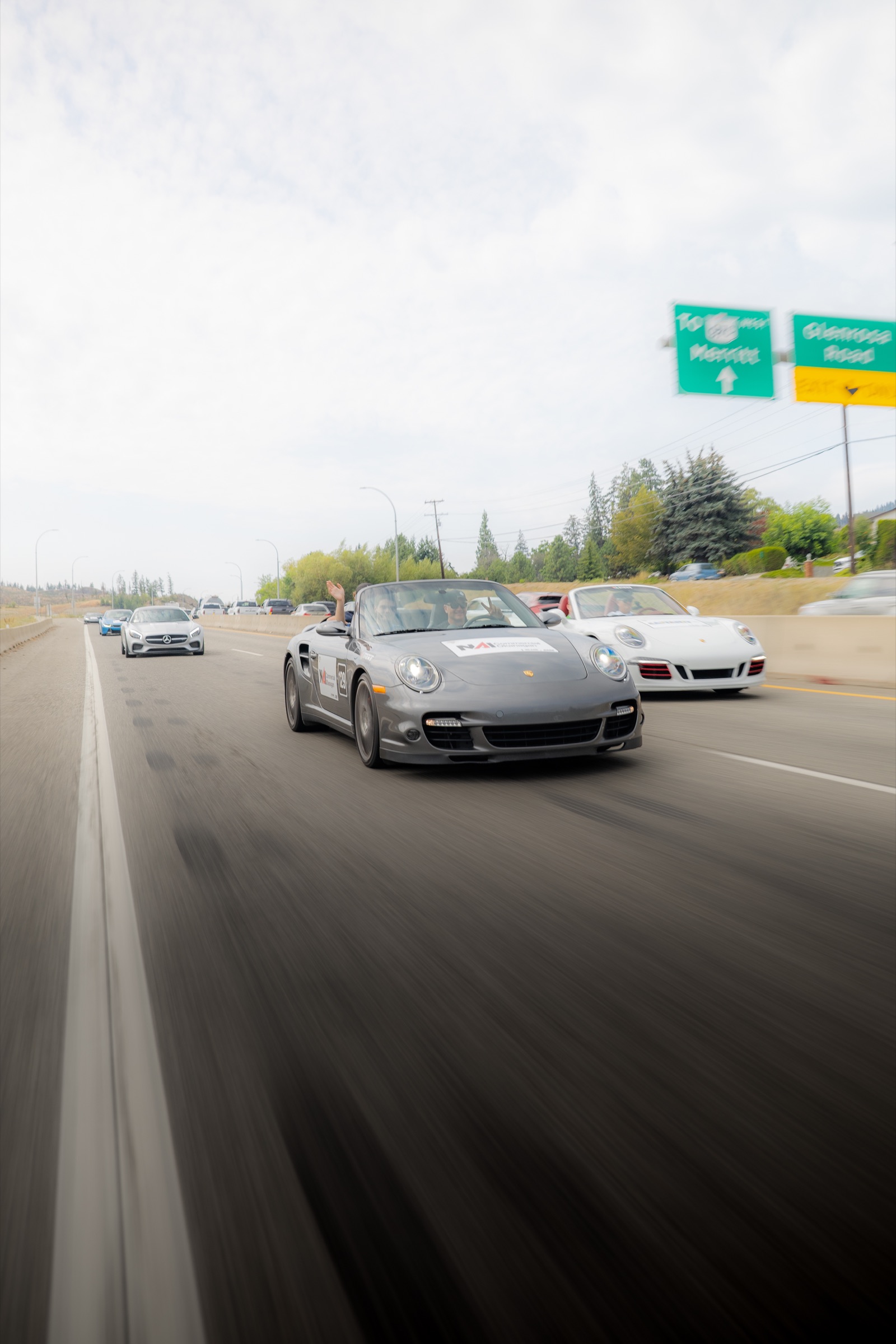 Porsche convertibles travelling through West Kelowna during the Dream Rally