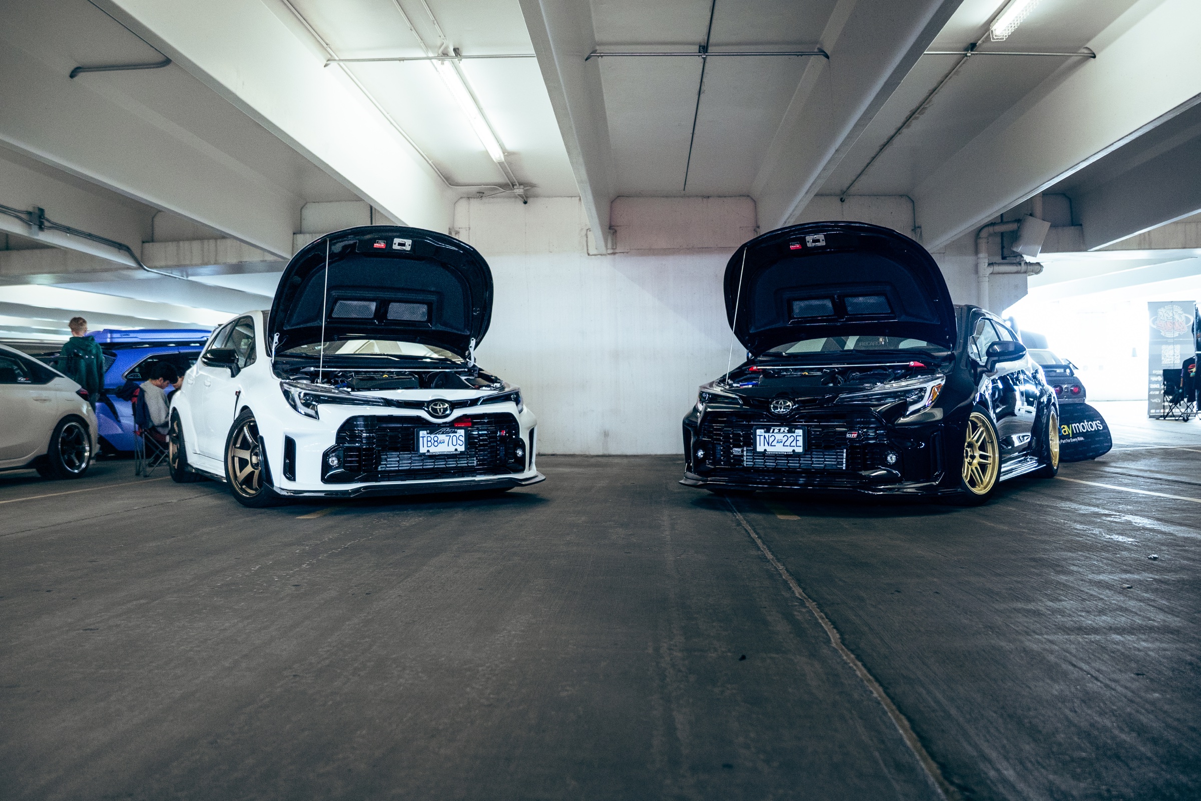 White and black Toyota GR Corollas displayed together