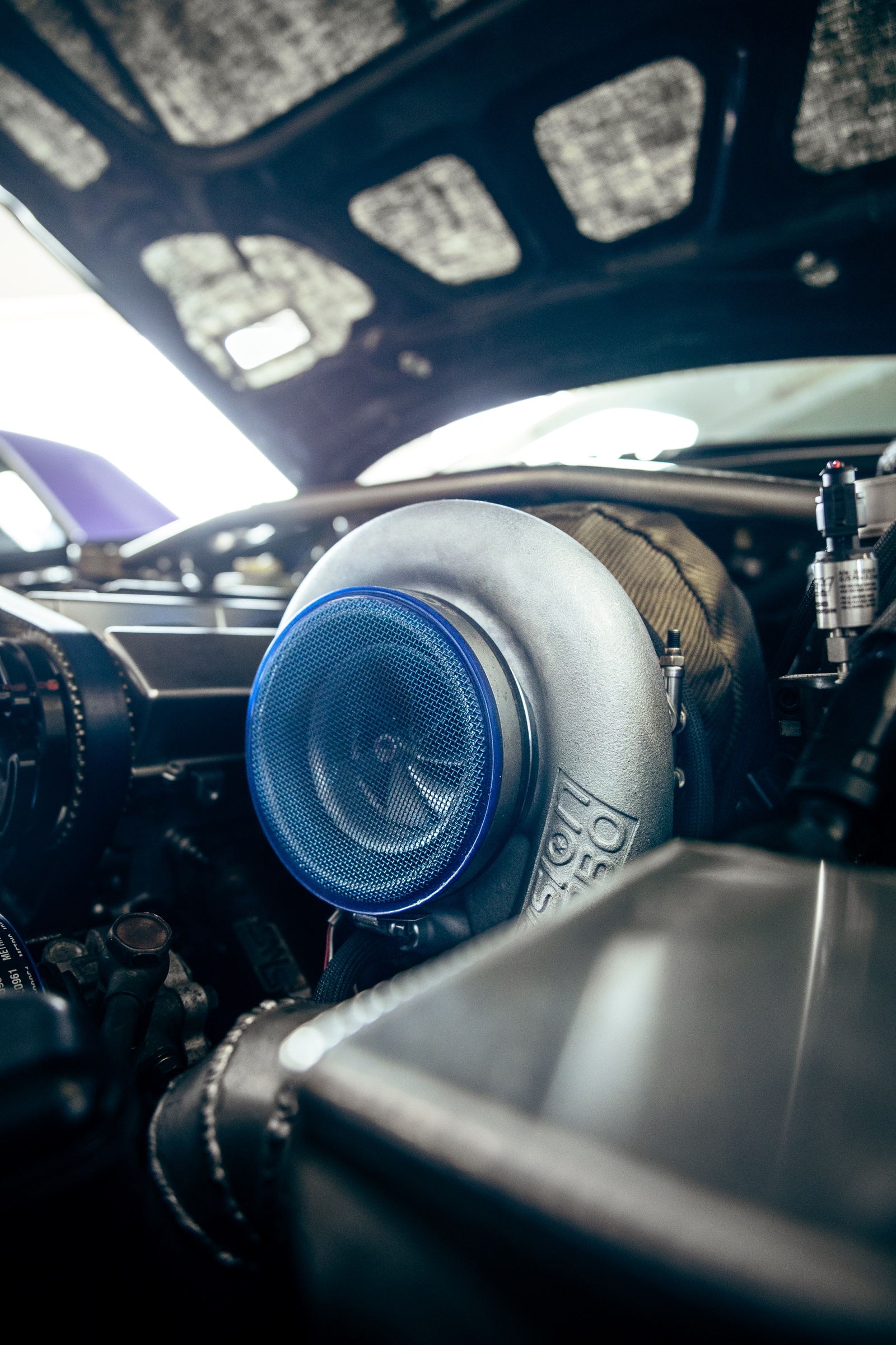 Close-up of a large turbocharger in a show-car engine bay