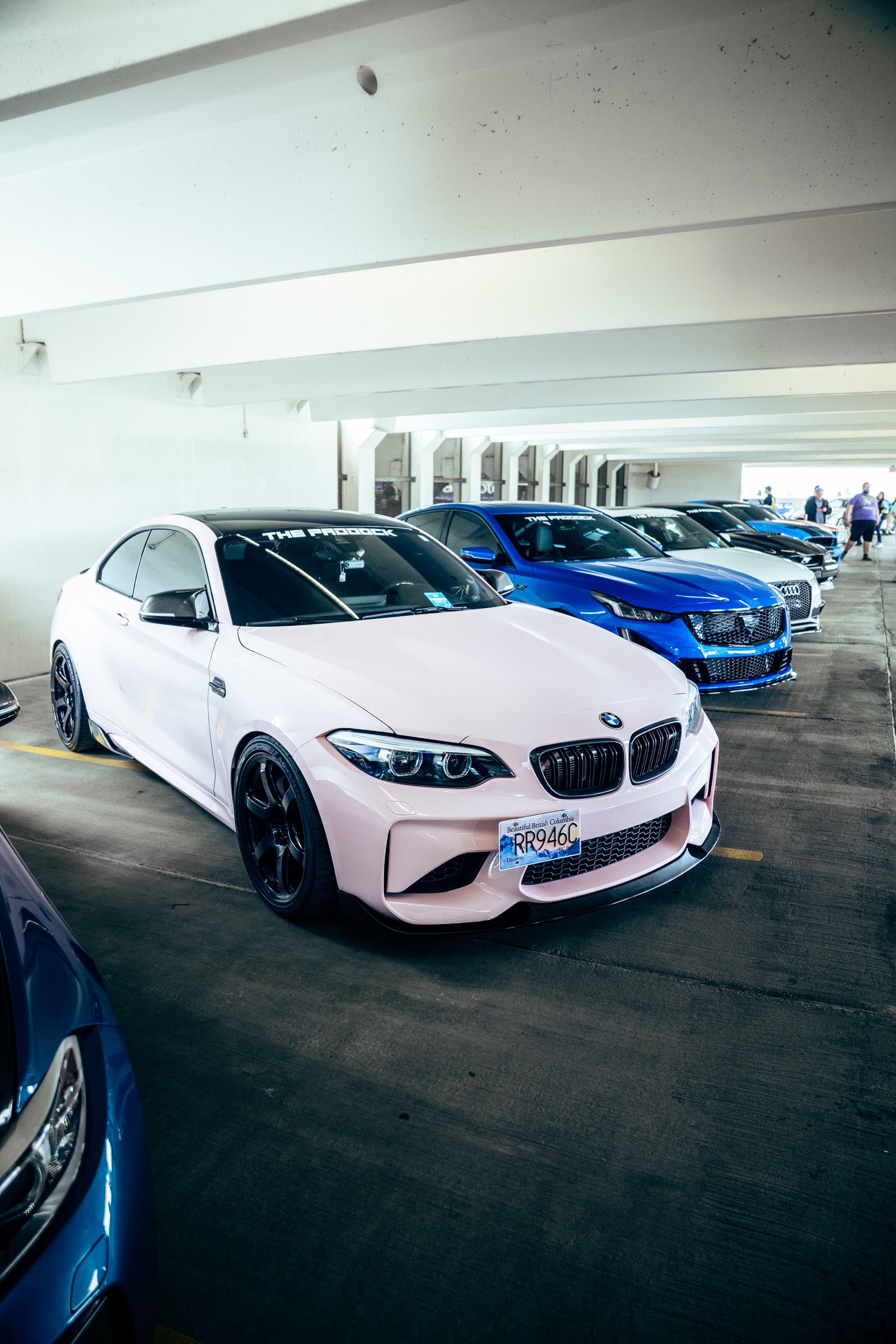 Indoor lineup of modified European cars led by a BMW M2