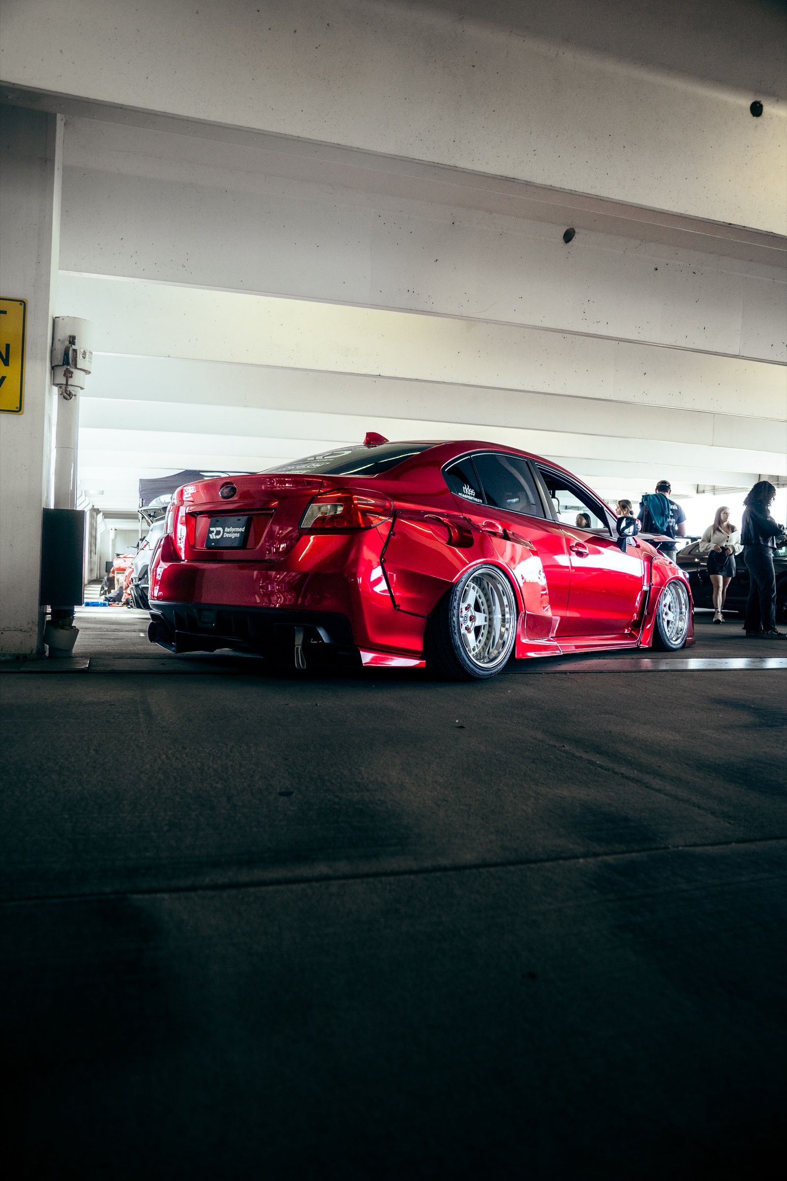 Red widebody Subaru photographed from the rear