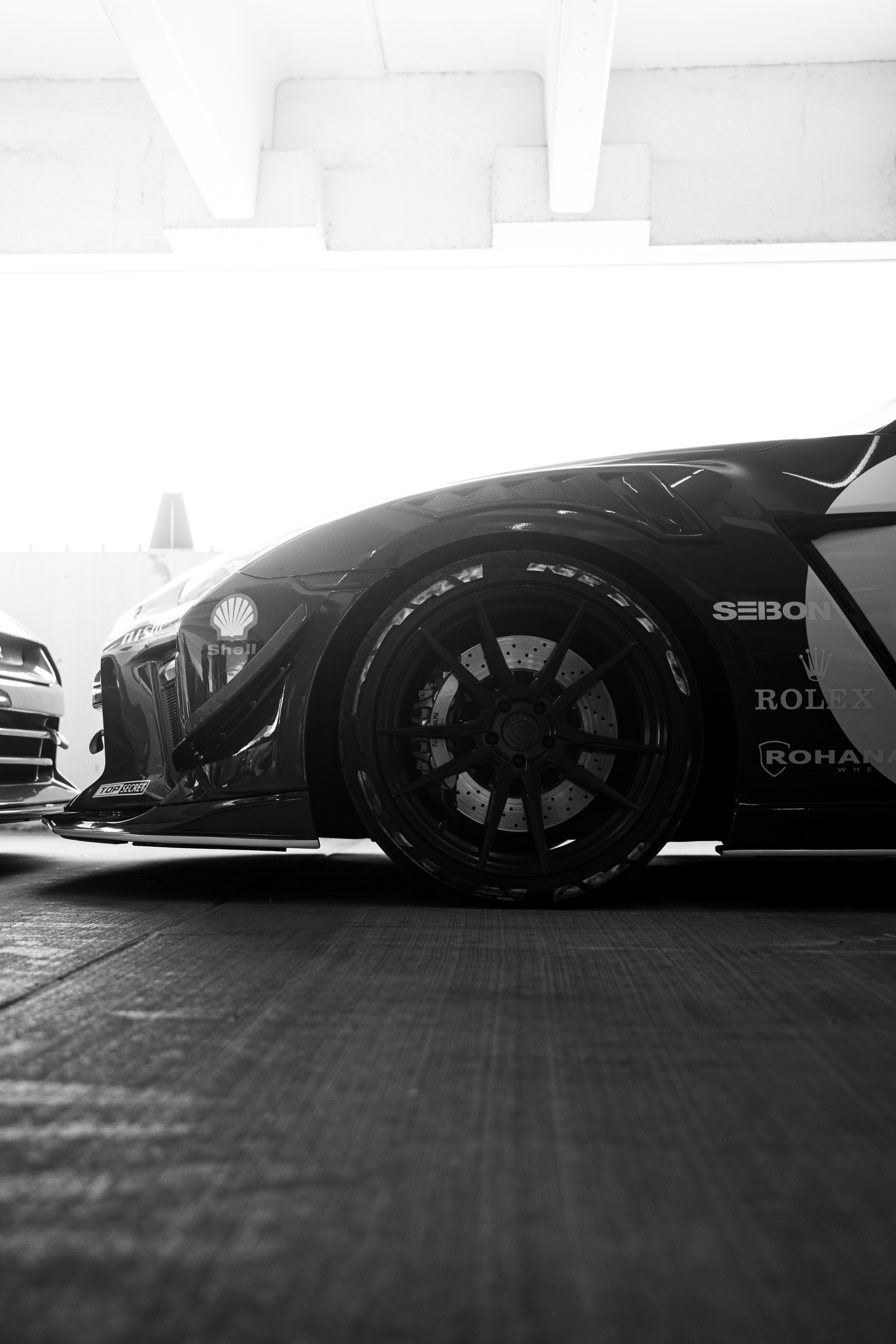 Black-and-white Nissan GT-R wheel and bodywork detail