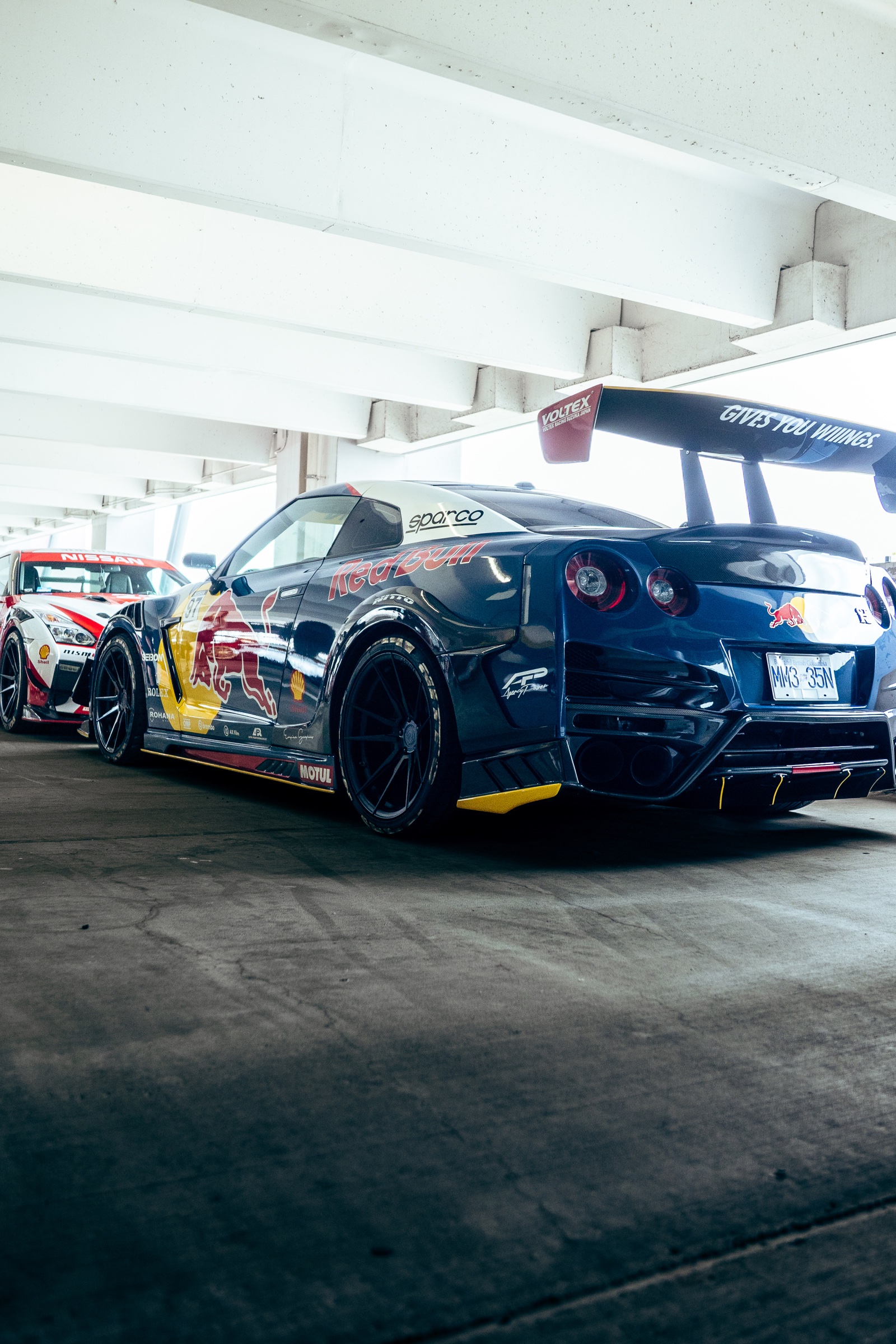Red Bull liveried Nissan GT-R pair inside the show