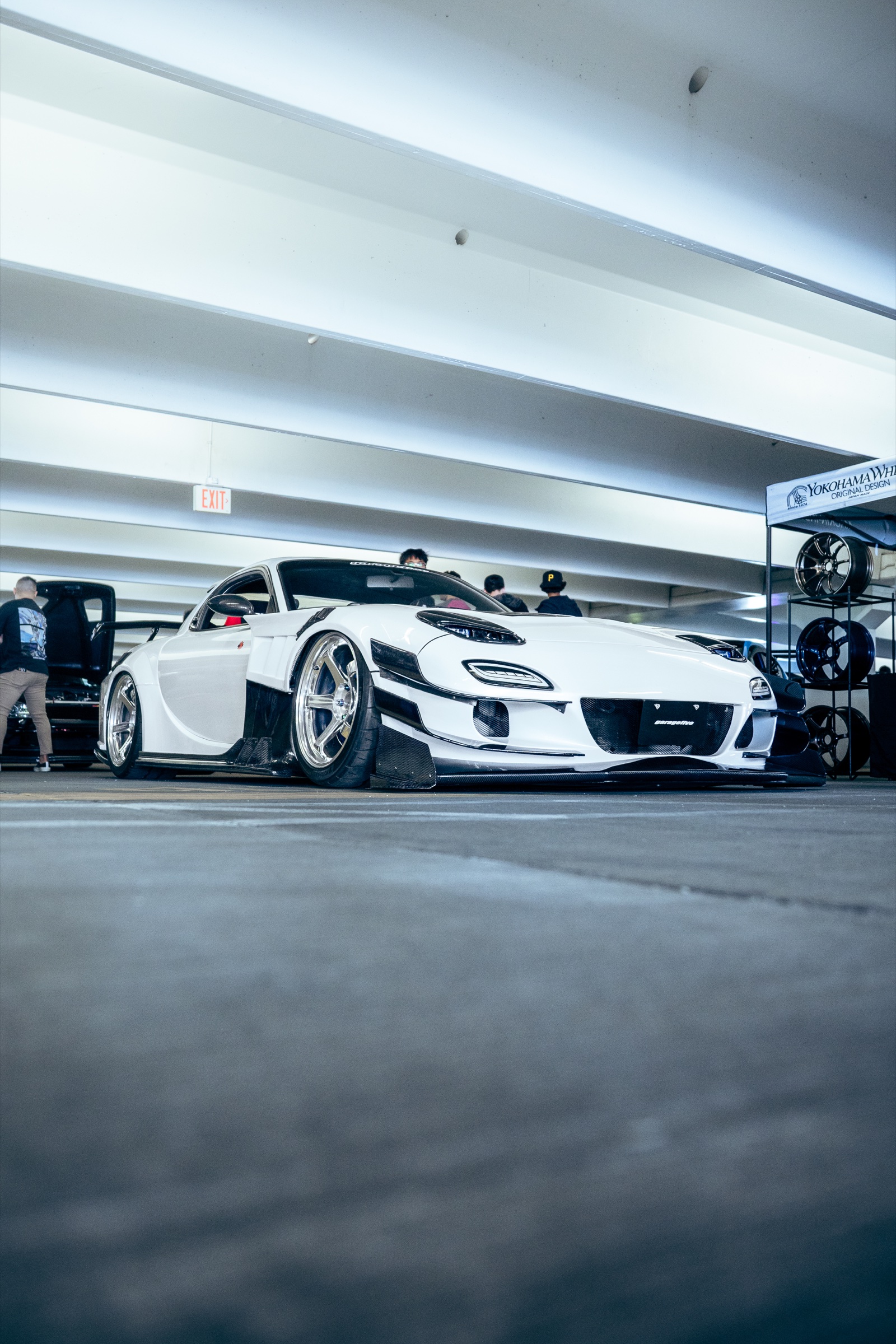 Low-angle portrait of a white Mazda RX-7