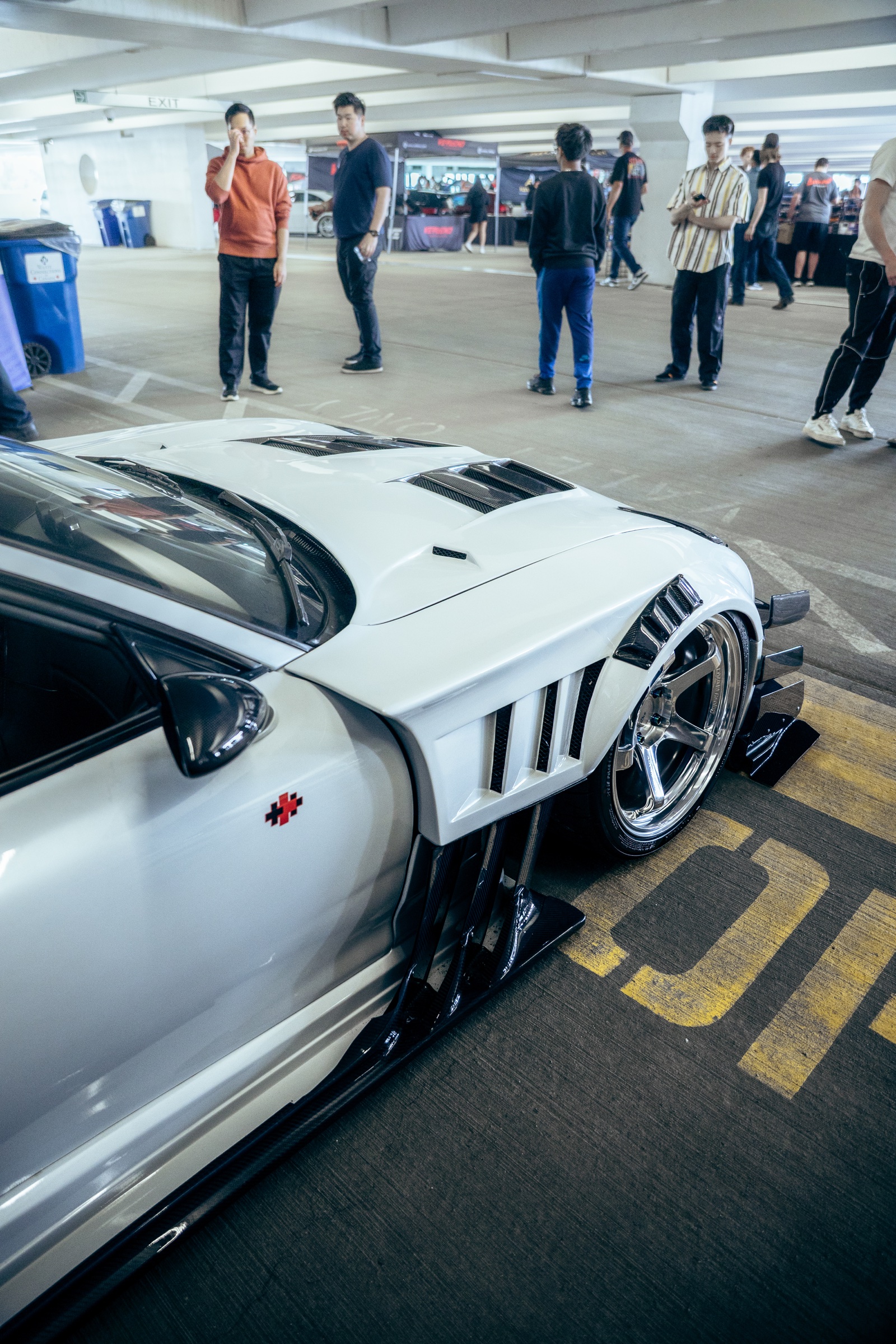 Wheel, vent, and aero detail on a white Mazda RX-7