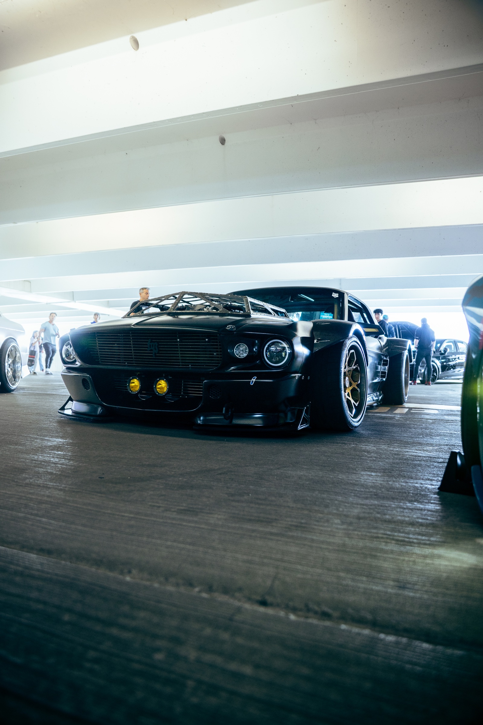 Front view of a black custom widebody Mustang