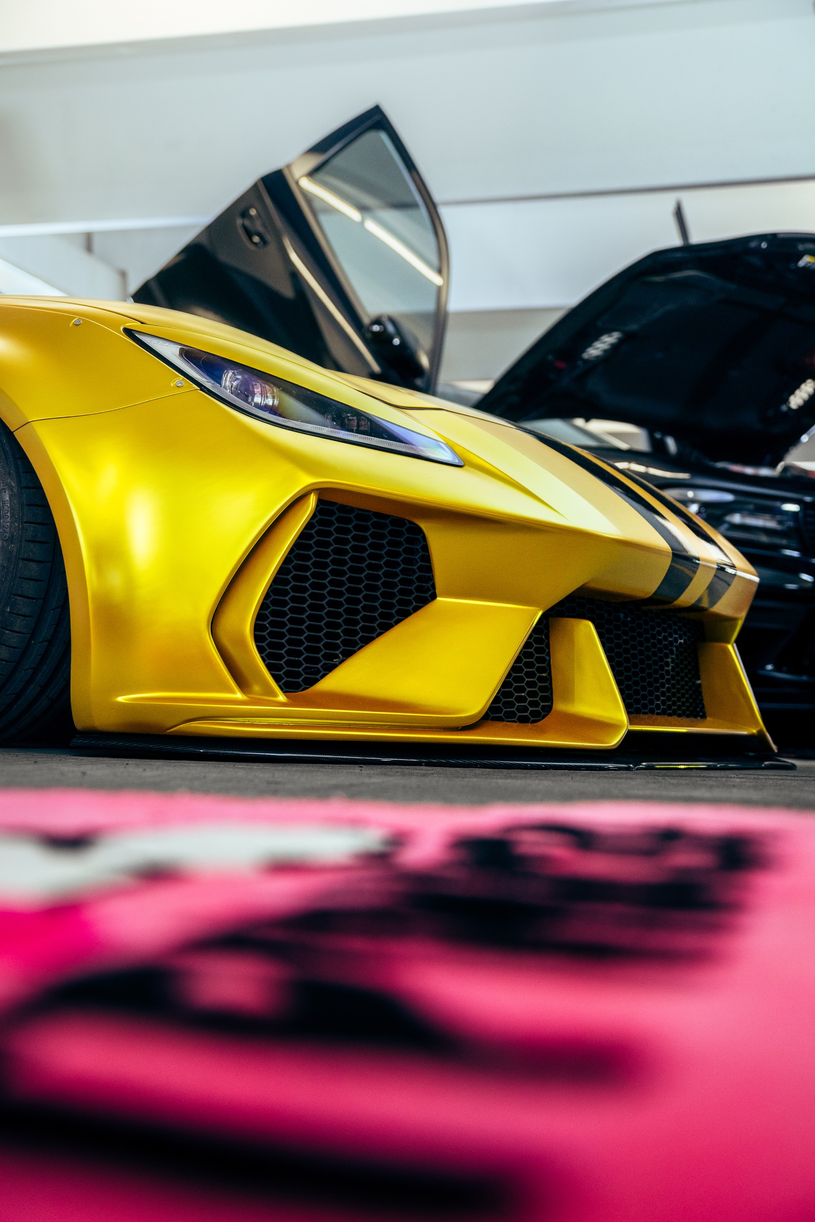 Front bumper detail on a gold custom sports car