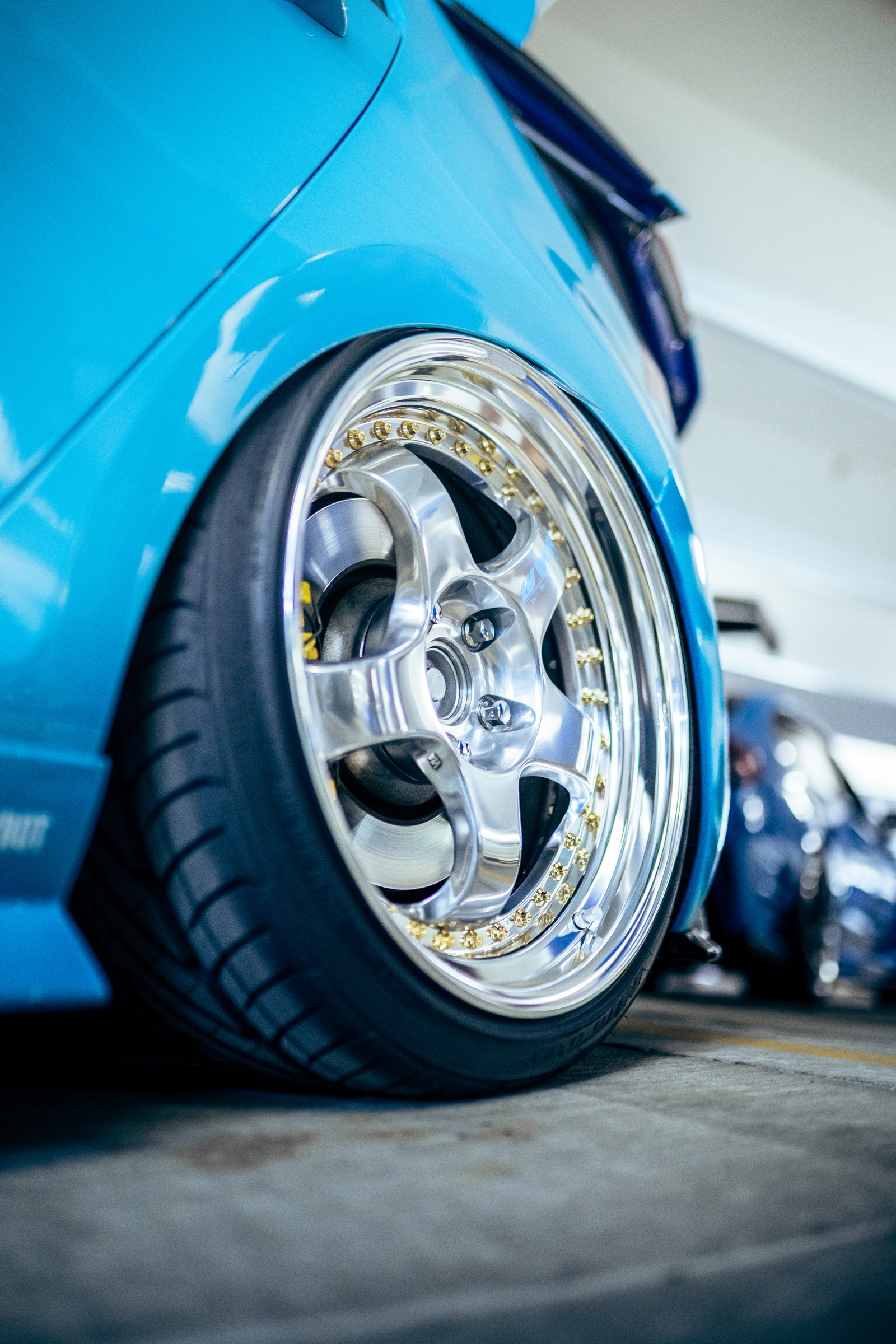 Polished wheel detail on a blue Volkswagen Golf