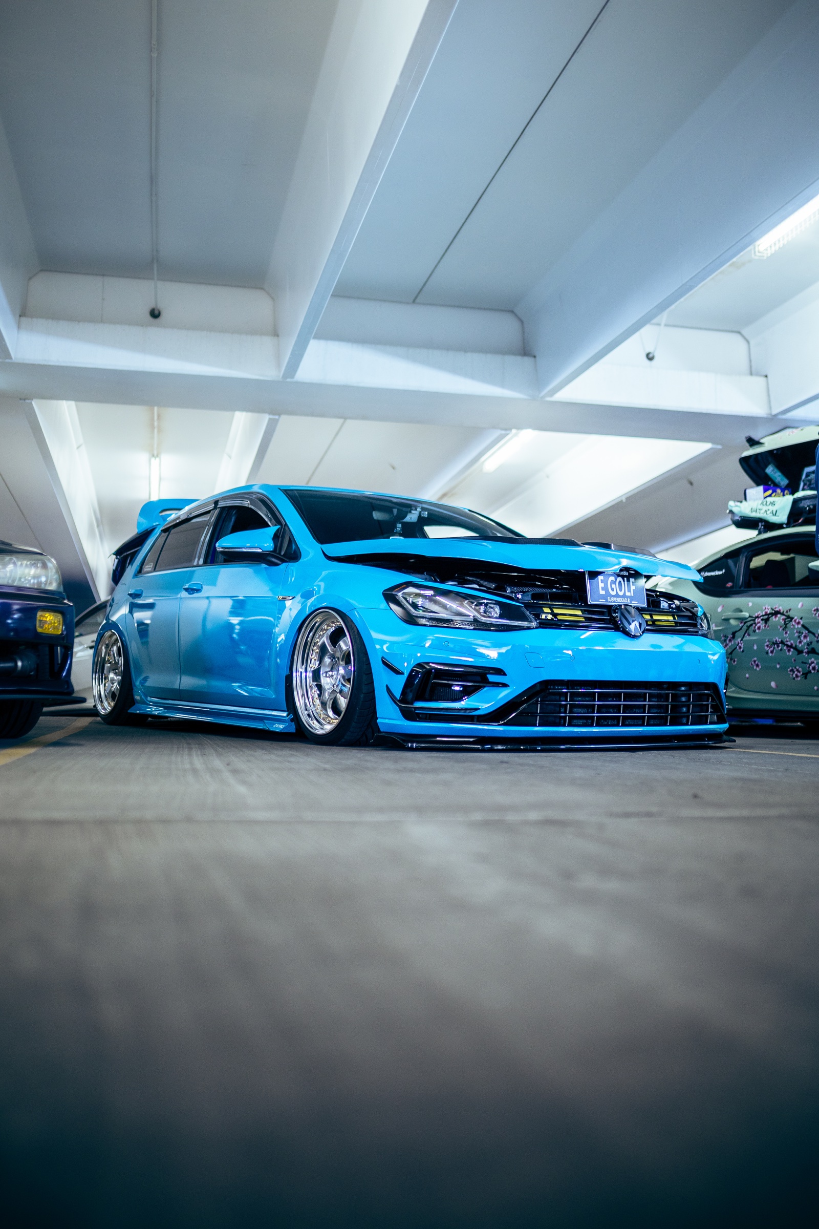 Blue modified Volkswagen Golf photographed from a low angle
