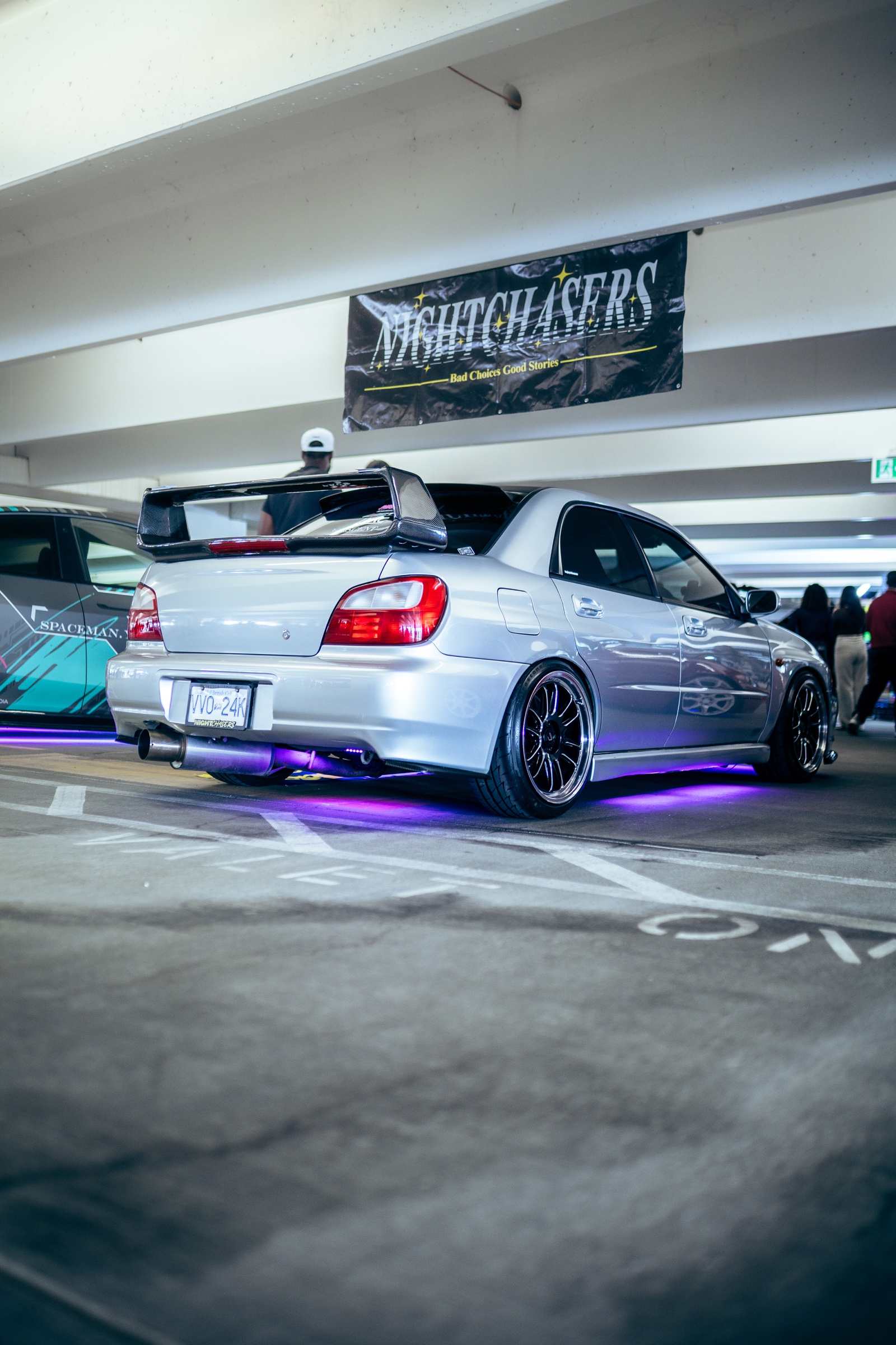 Silver Subaru with purple underglow inside Driven Vancouver