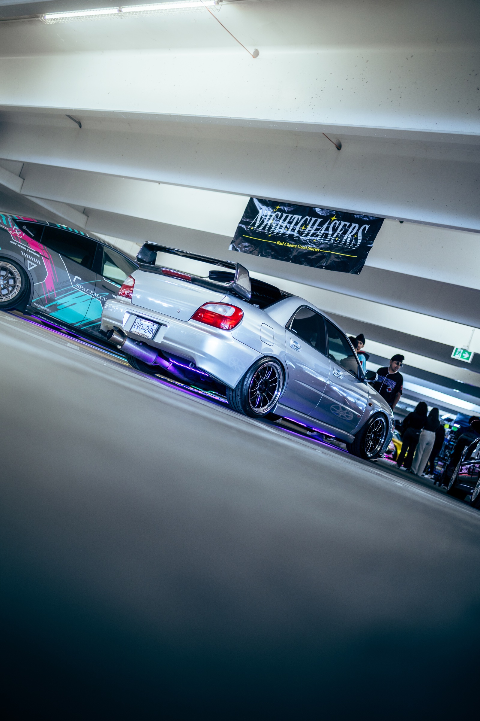 Silver Subaru with purple underglow and Nightchasers banner