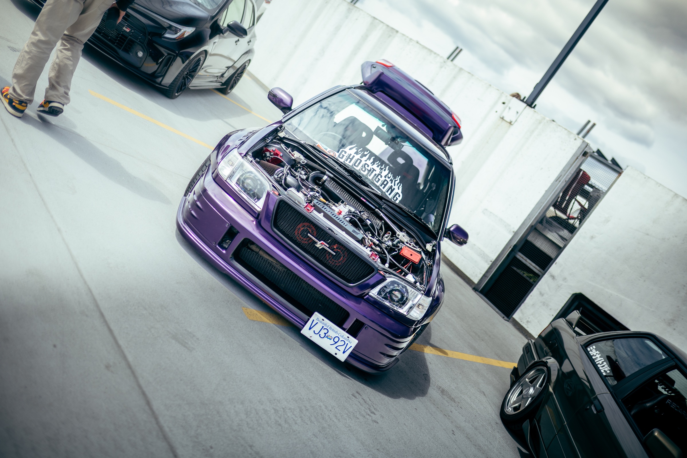 Purple modified hatchback with its engine bay on display
