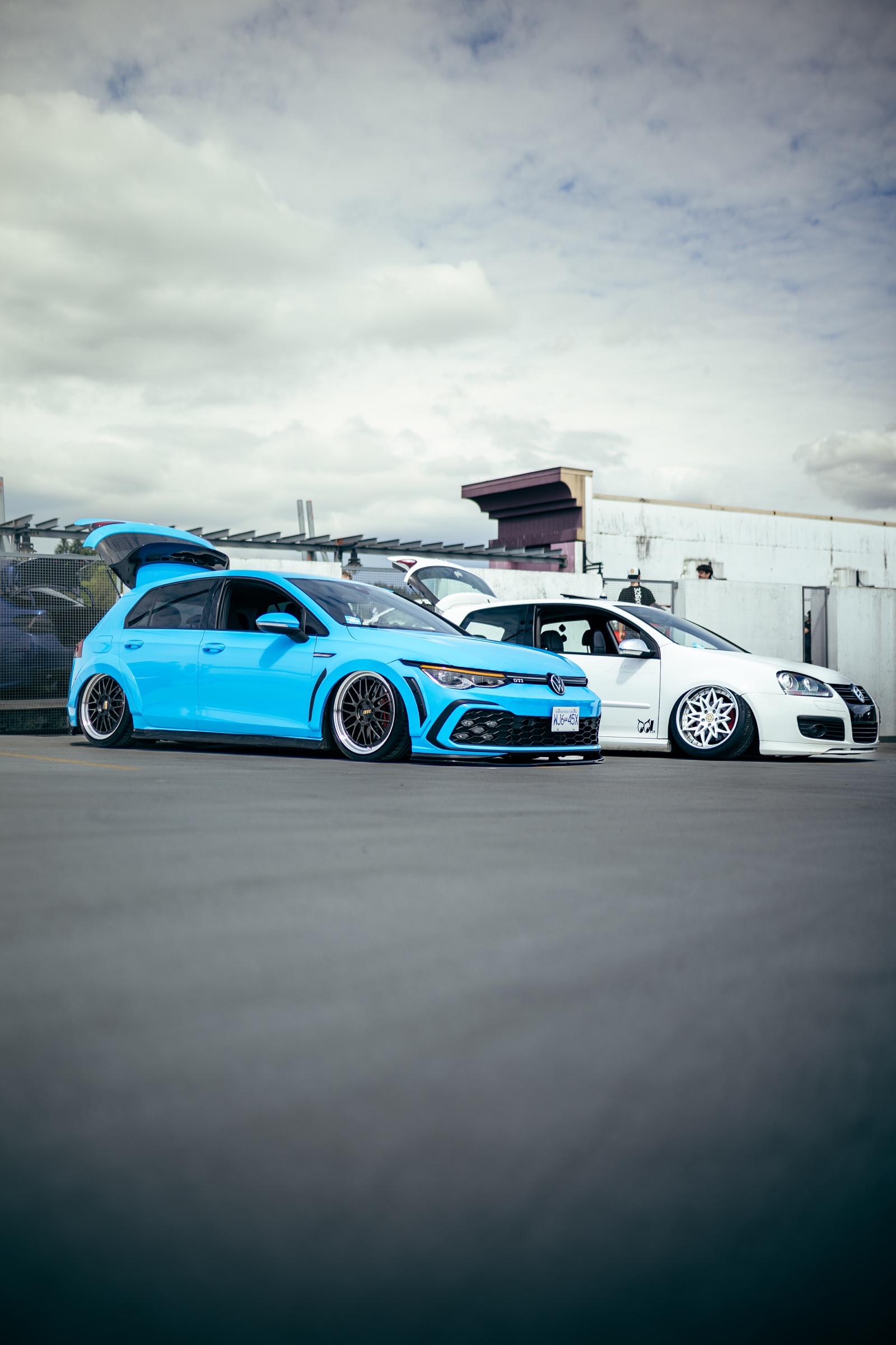 Blue and white modified Volkswagen Golfs displayed together