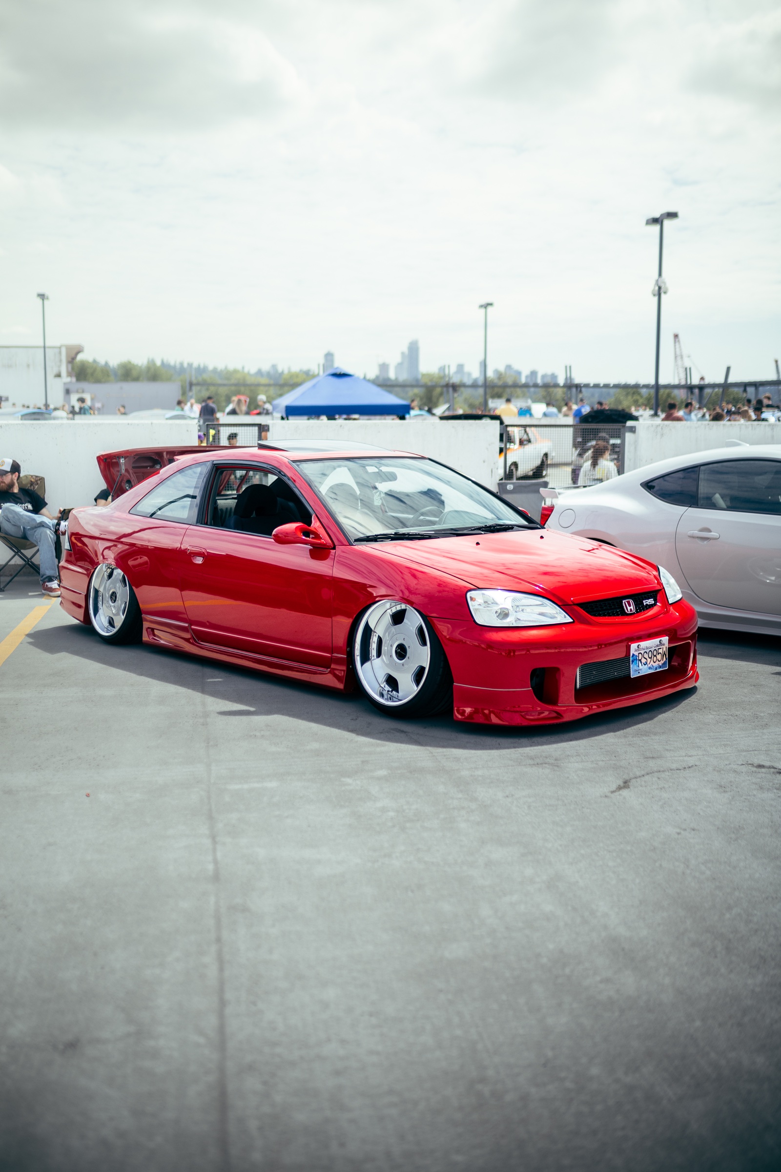 Red lowered Honda coupe displayed outdoors