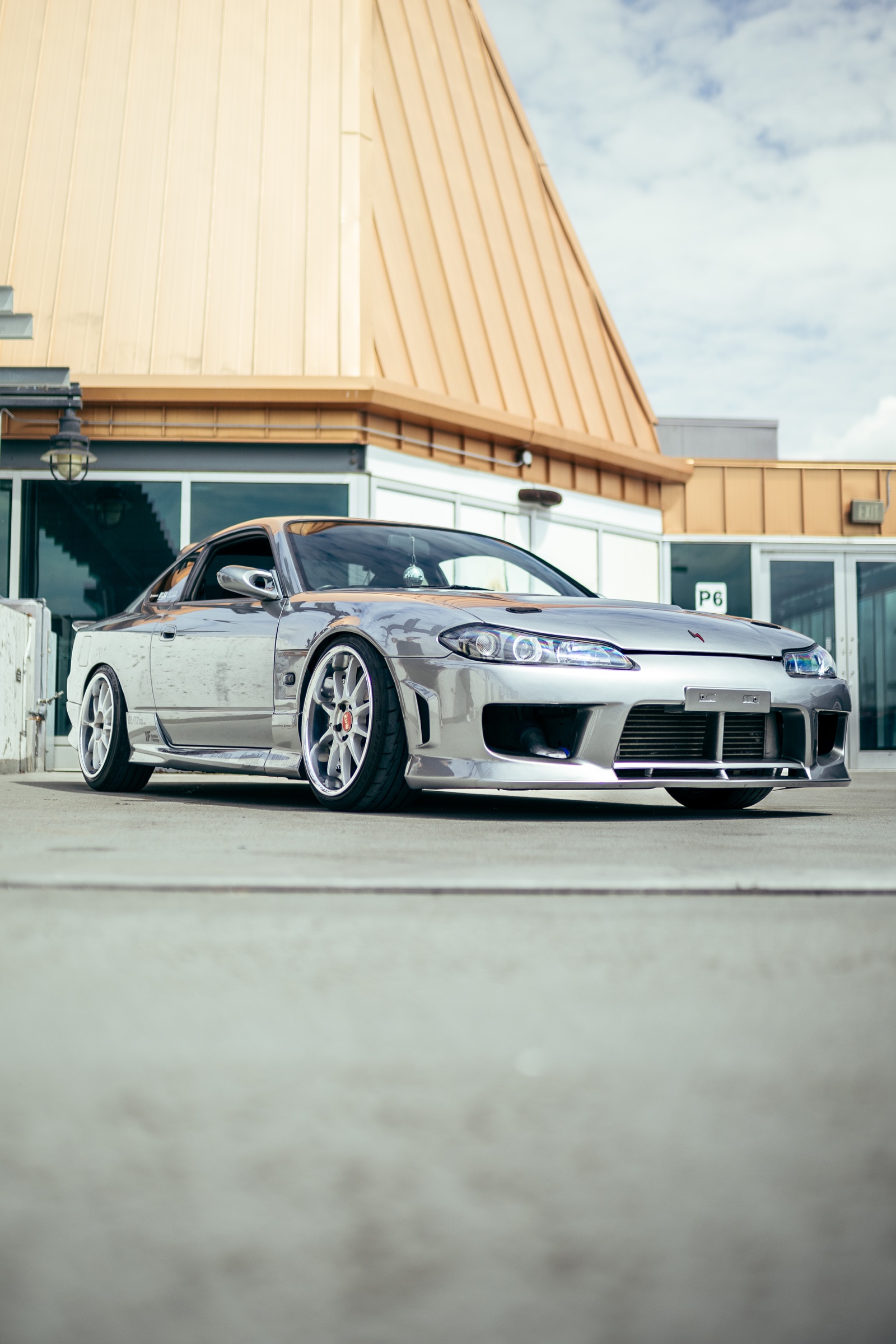 Silver Nissan Silvia displayed on the parkade rooftop