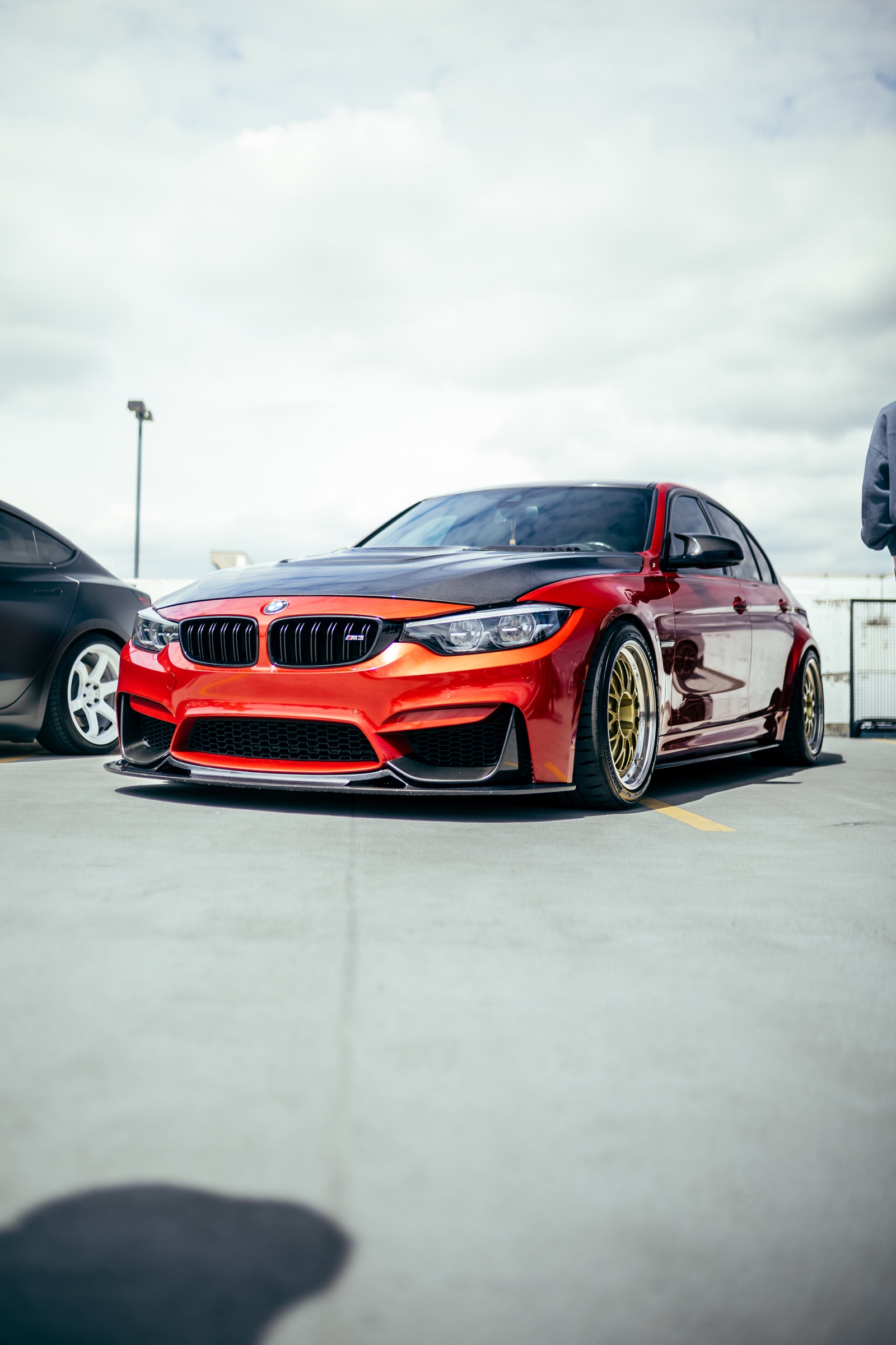 Red modified BMW M3 displayed outdoors at Driven Vancouver 2025