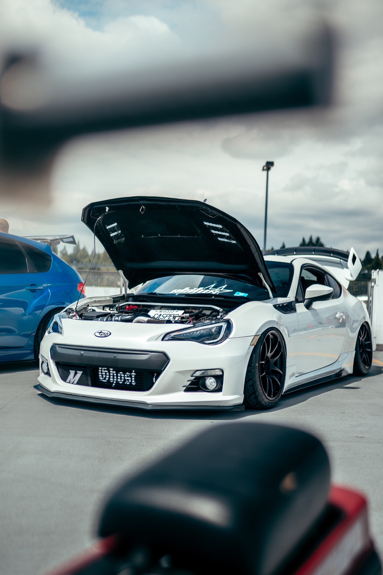 White modified Subaru BRZ with its hood open
