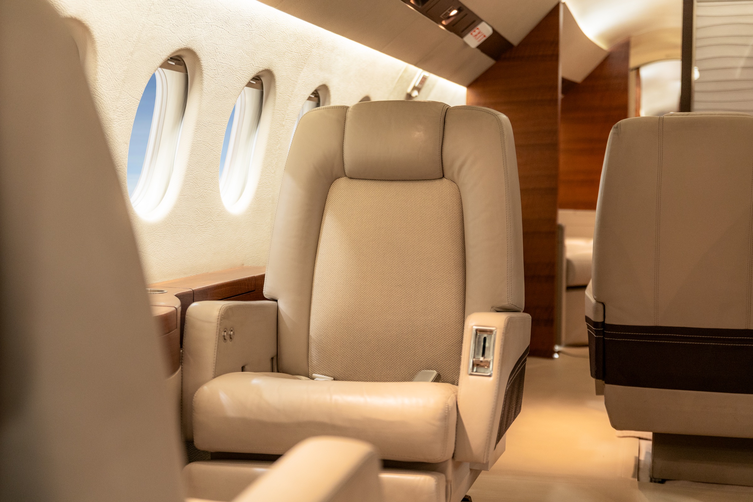 Falcon 900DX passenger seat beside the cabin windows