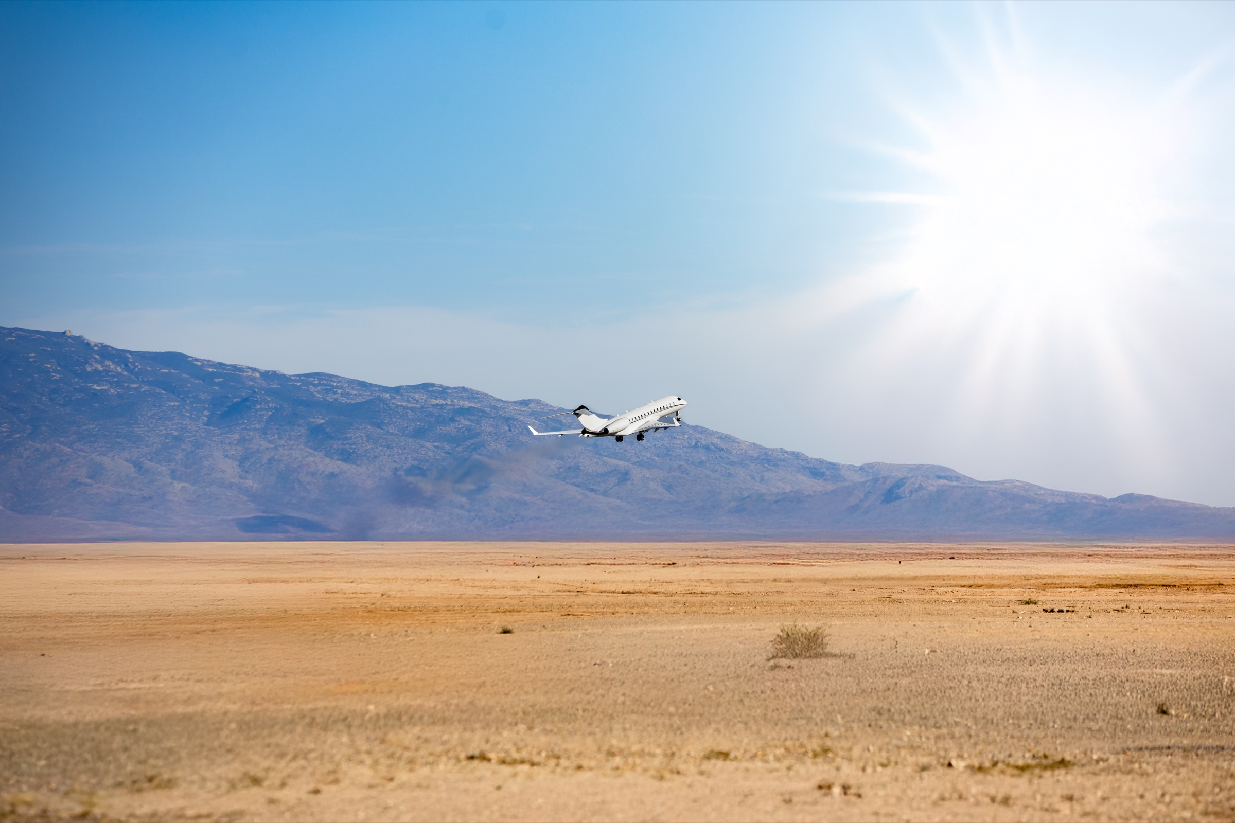 Global 6000 departing Tucson against the desert landscape