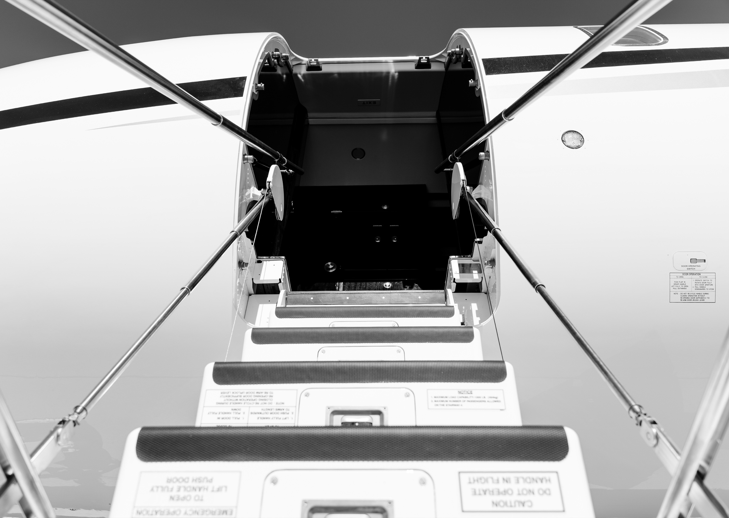 Black-and-white view up the Global 6000 entry stairs