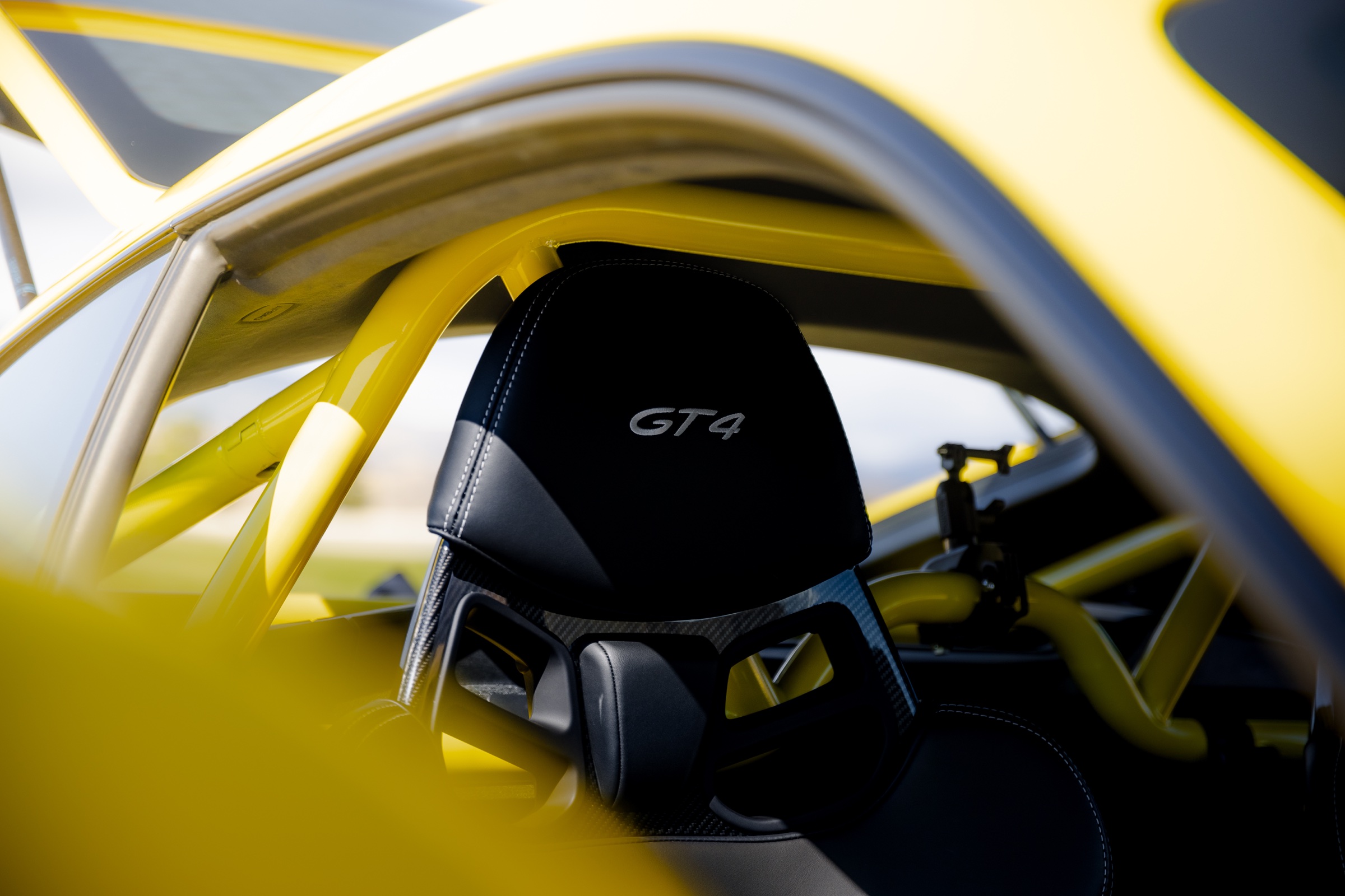 Porsche GT4 carbon seat and yellow roll-cage detail
