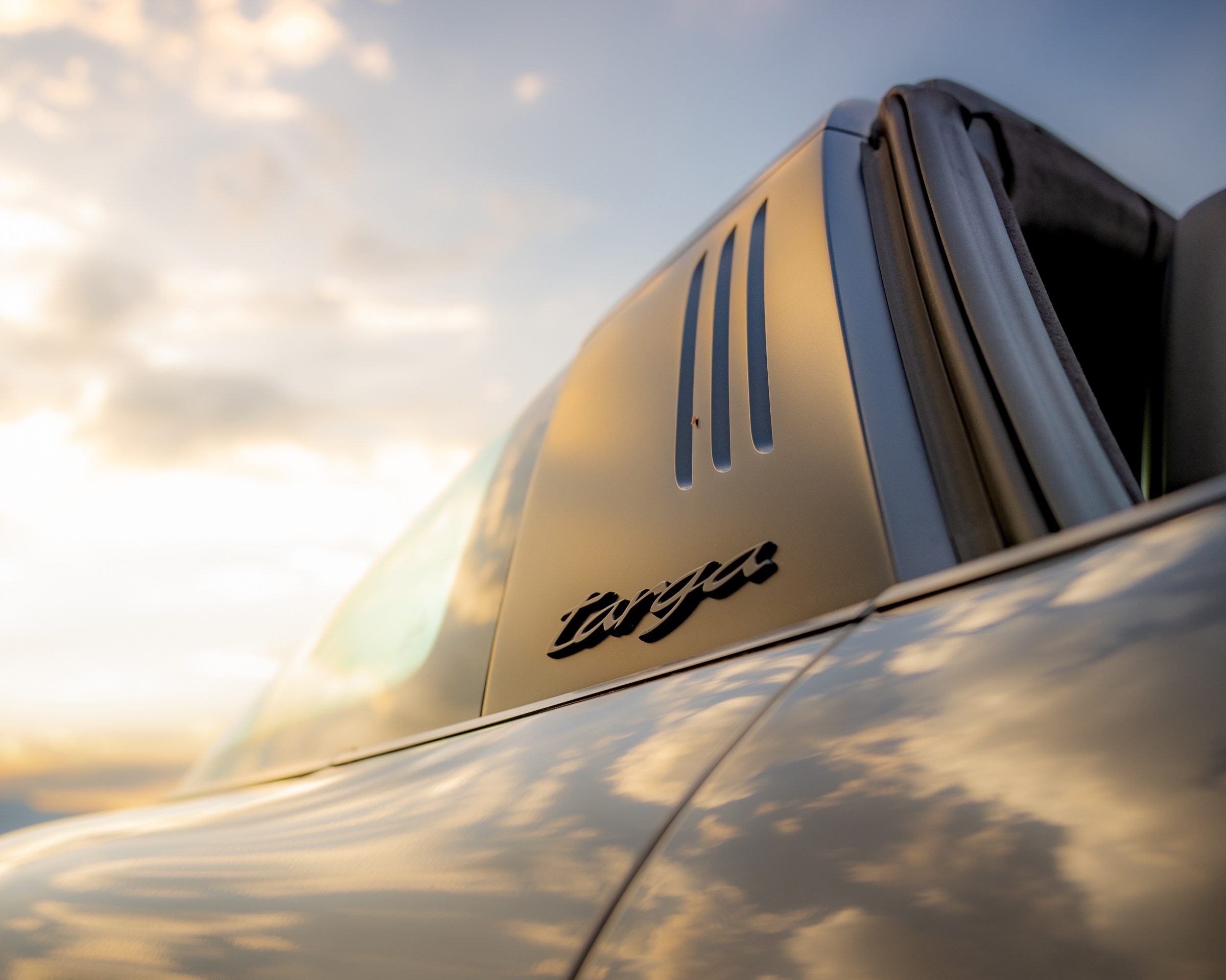 Porsche 911 Targa badge and roof detail reflecting the sunrise