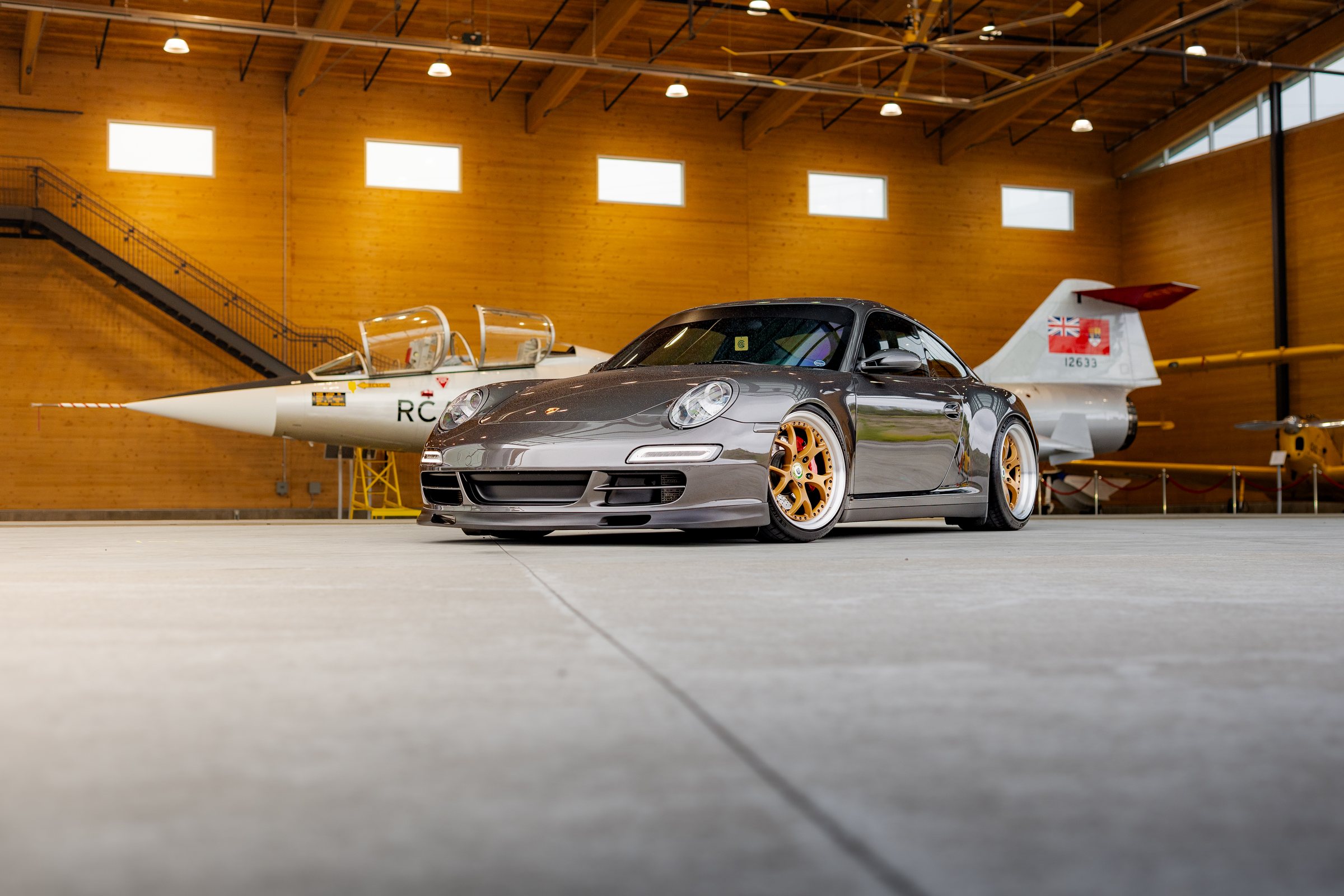Porsche Club car displayed in the aviation hangar