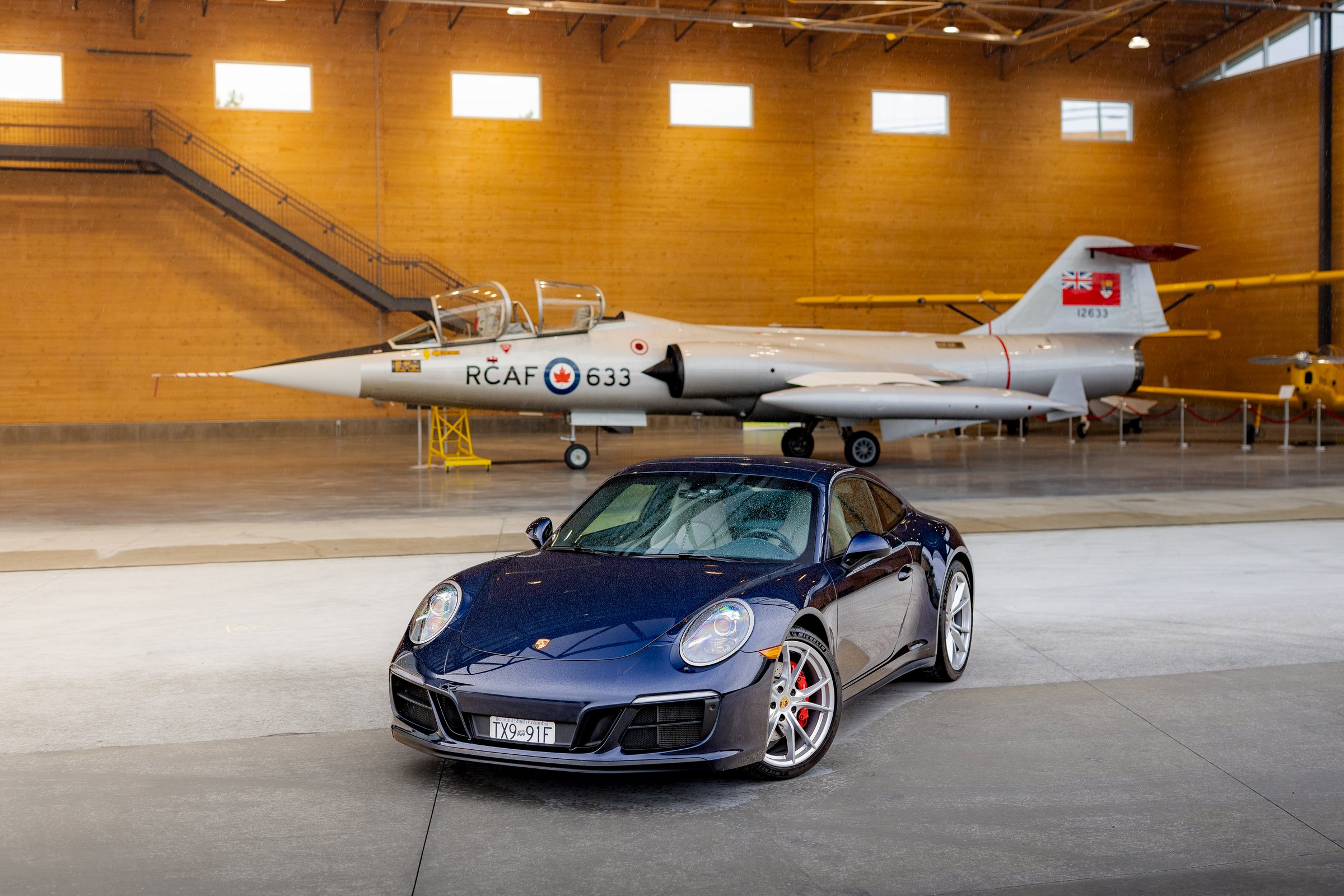 Porsche Club car photographed on the polished hangar floor