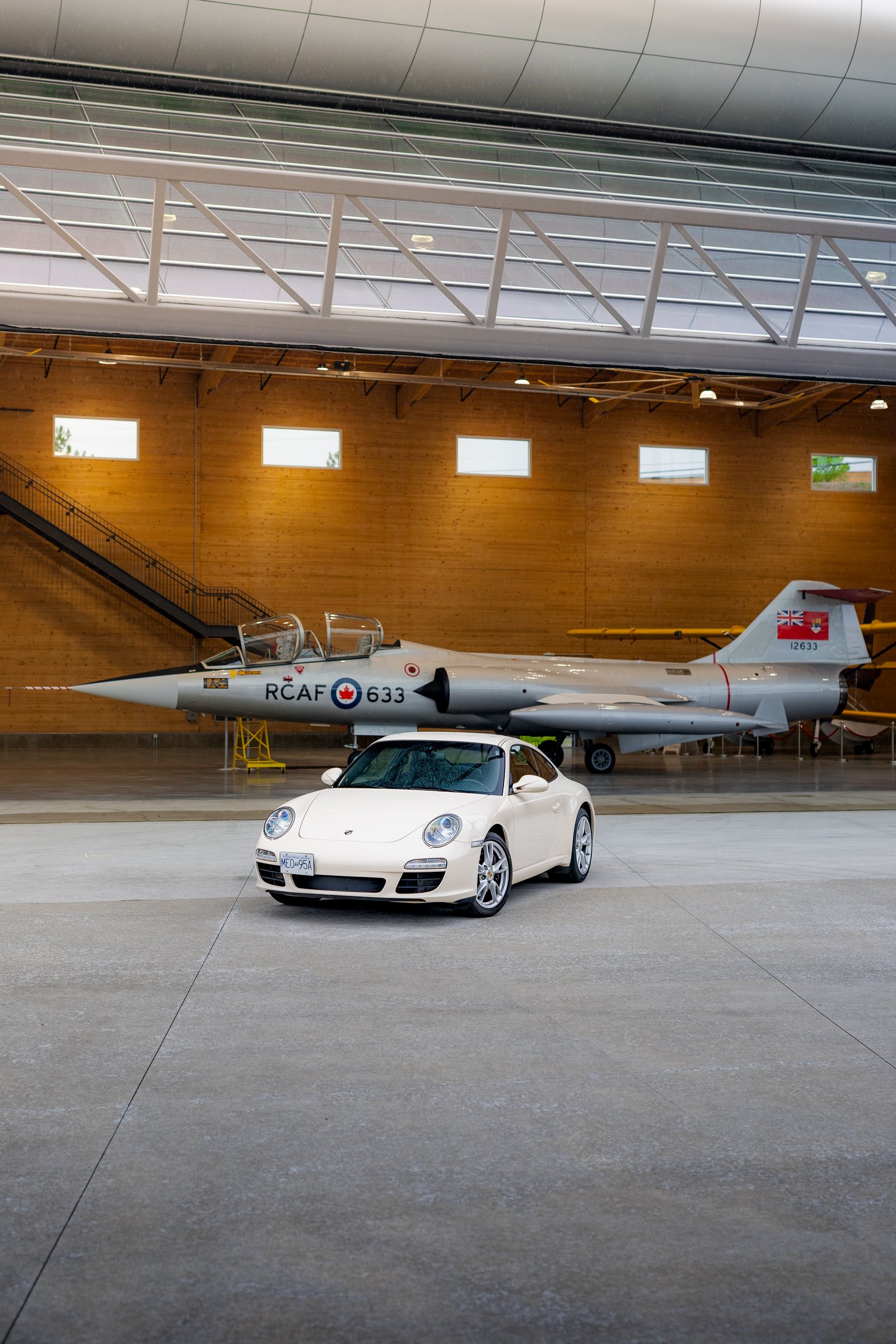 Vertical Porsche portrait inside the timber hangar