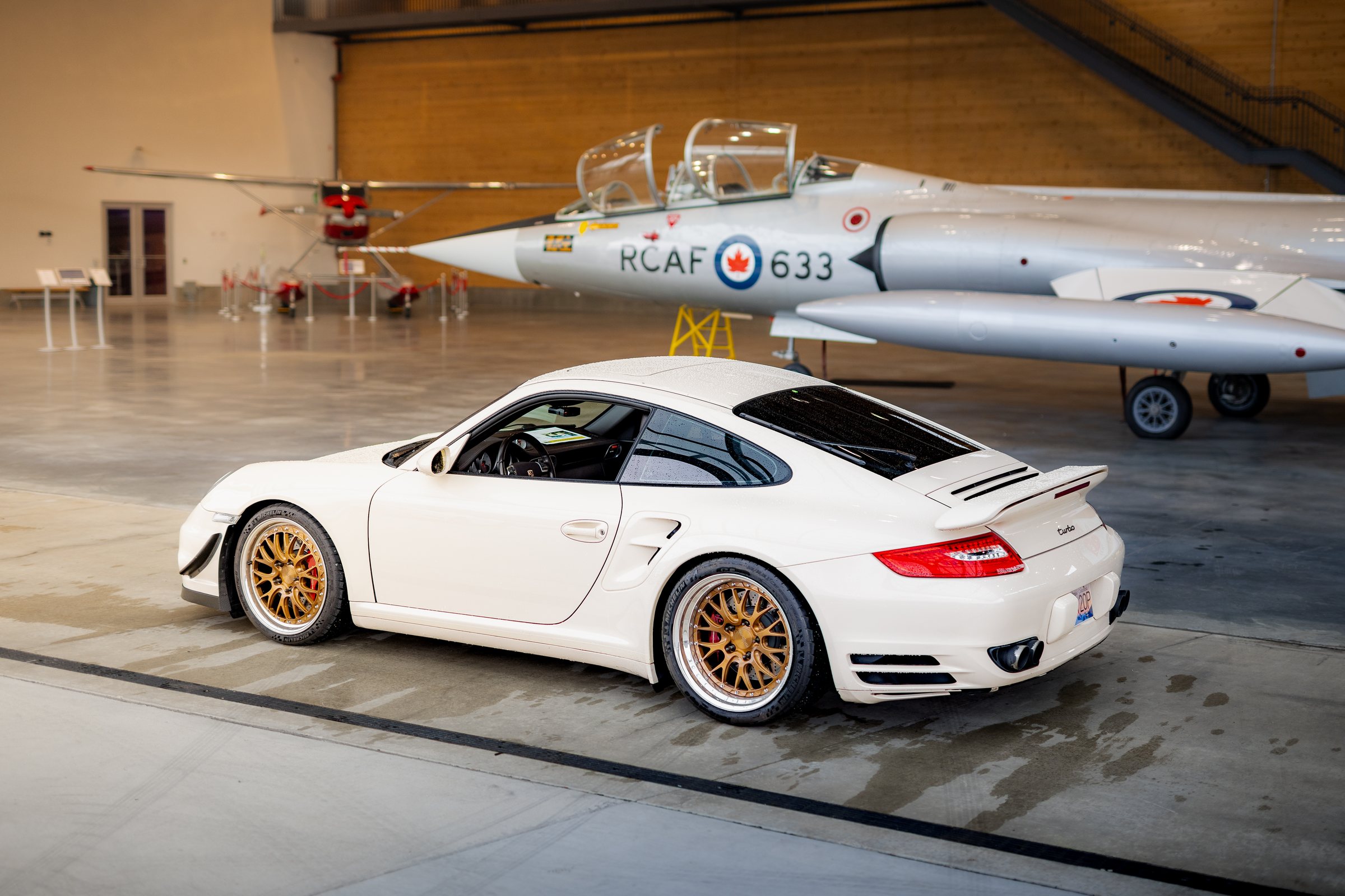 White Porsche 911 Turbo photographed with an RCAF aircraft