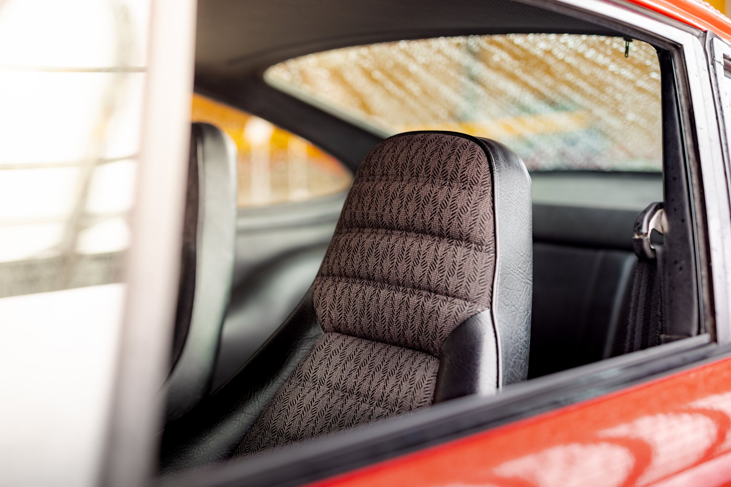 Patterned seat upholstery inside a classic Porsche