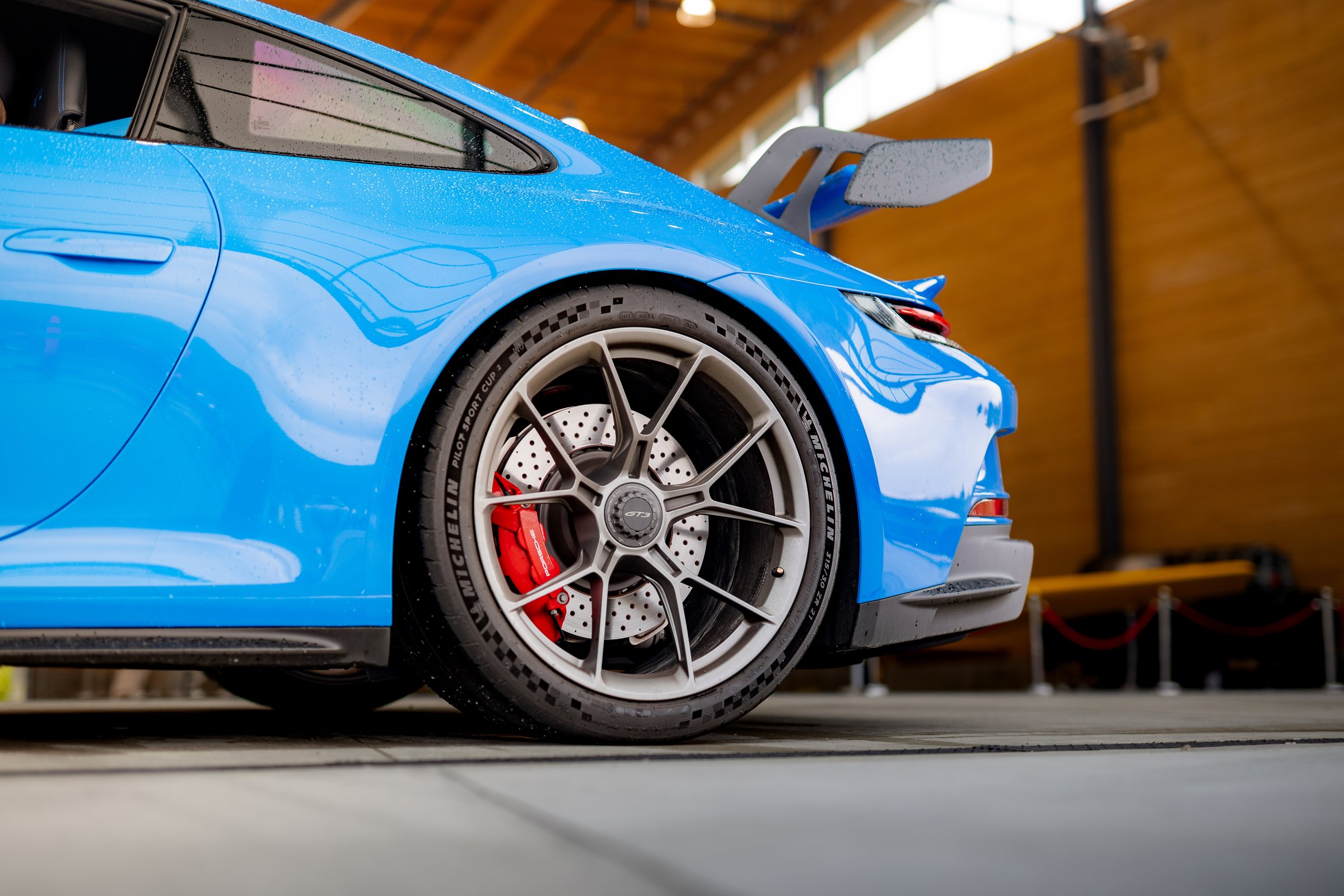 Blue Porsche 911 GT3 rear wheel and wing detail
