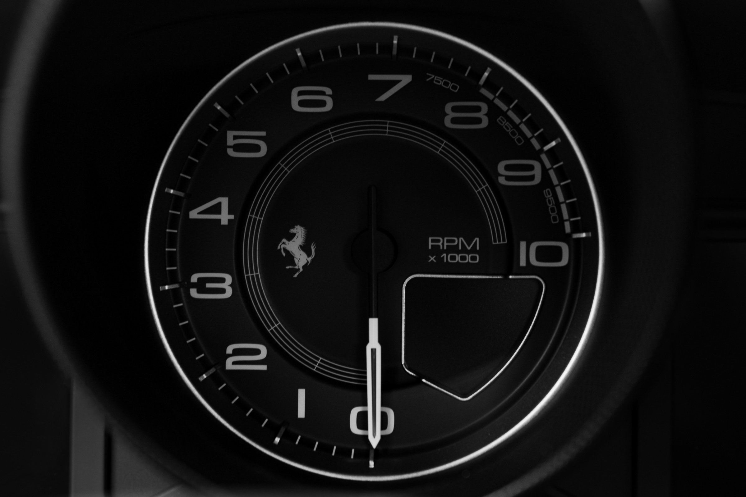 Black-and-white Ferrari tachometer detail
