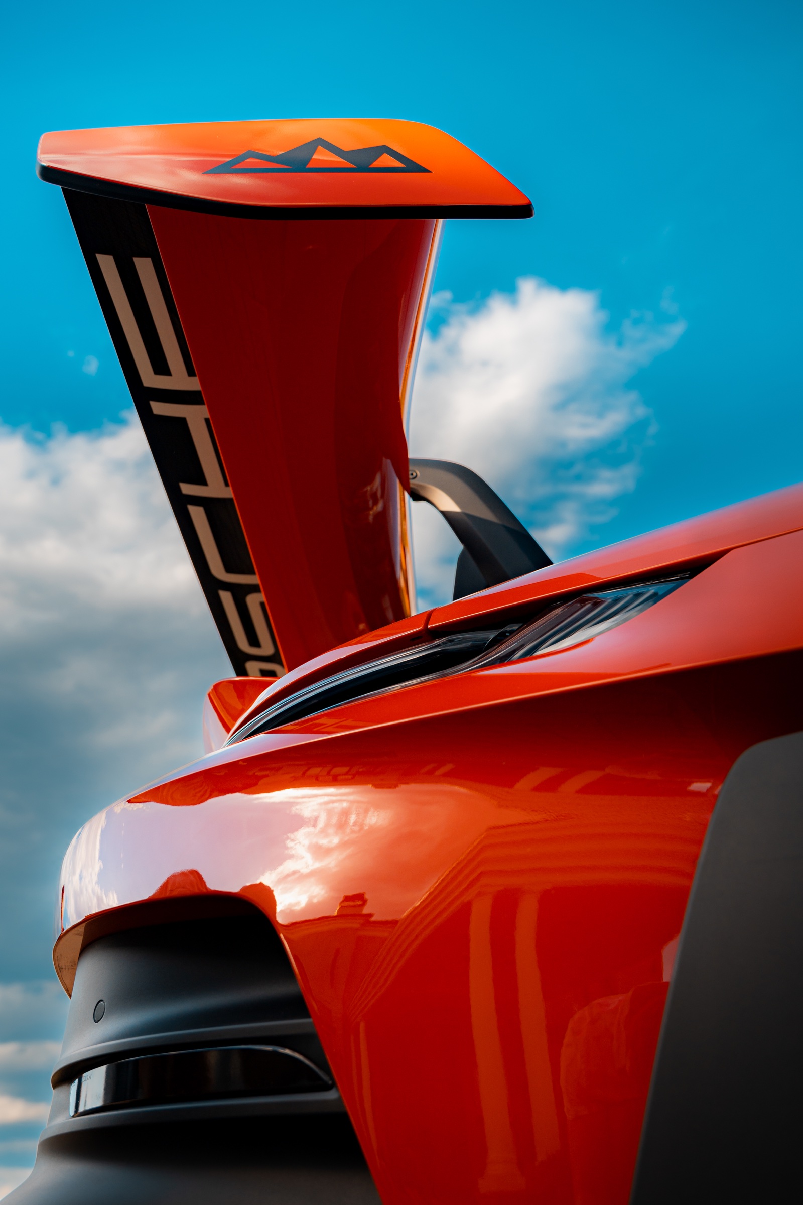 Raised rear wing and bodywork of a red Porsche 911 GT3 RS