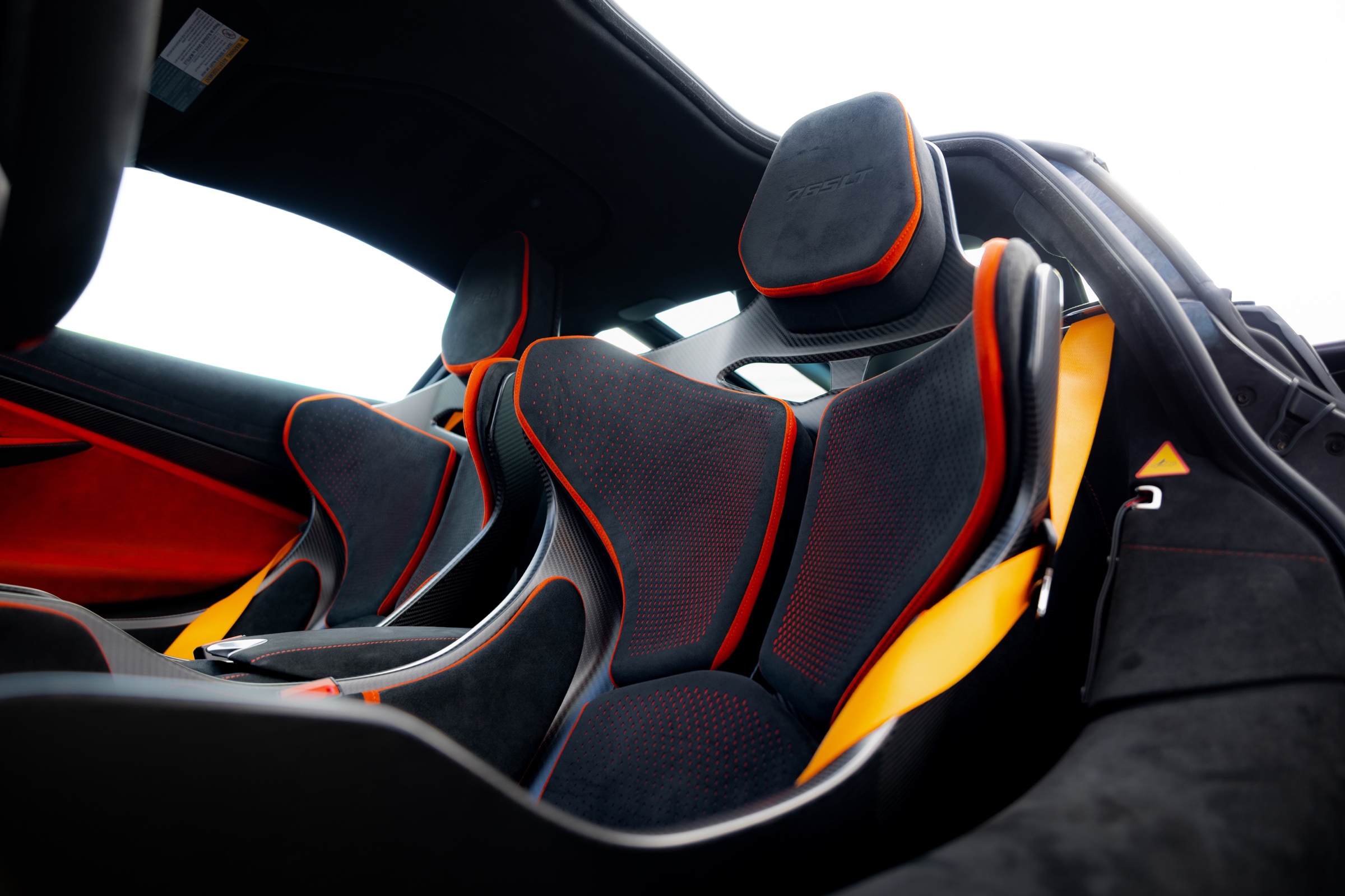 Carbon-fibre seats and orange harnesses inside a McLaren 765LT