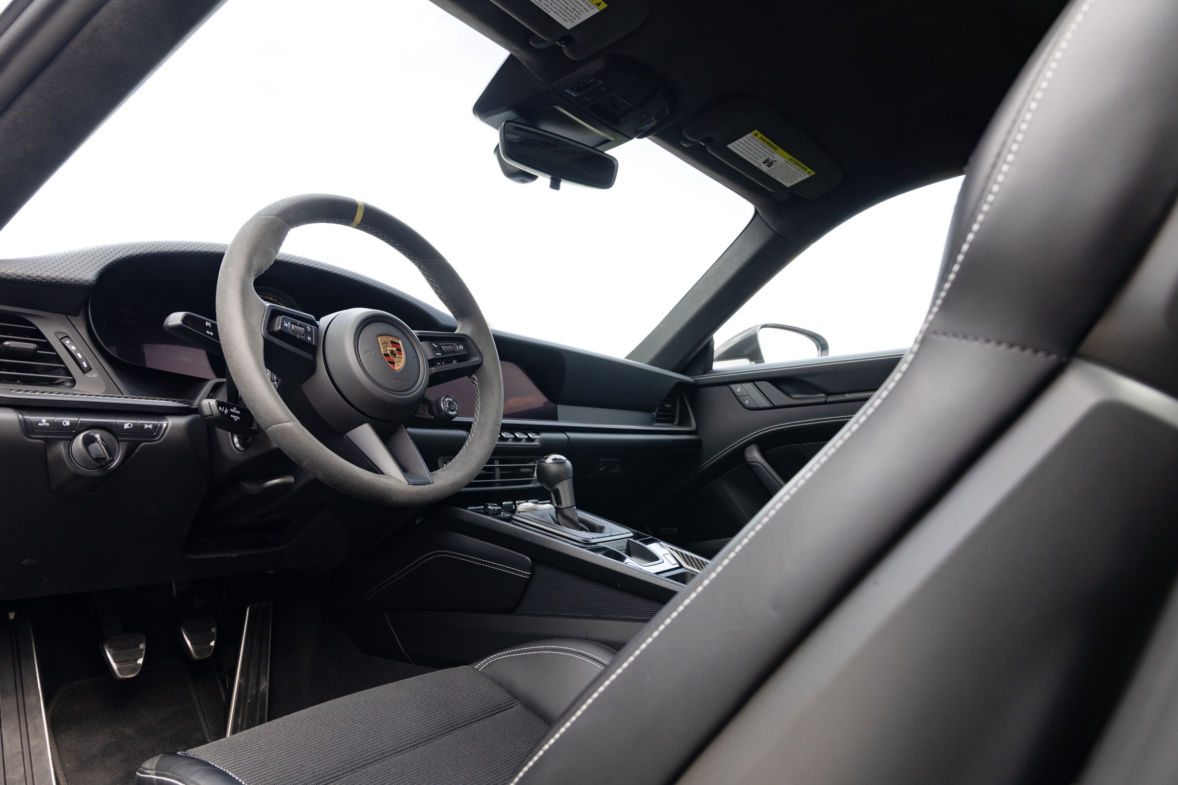 Driver-focused cockpit inside a Porsche 911