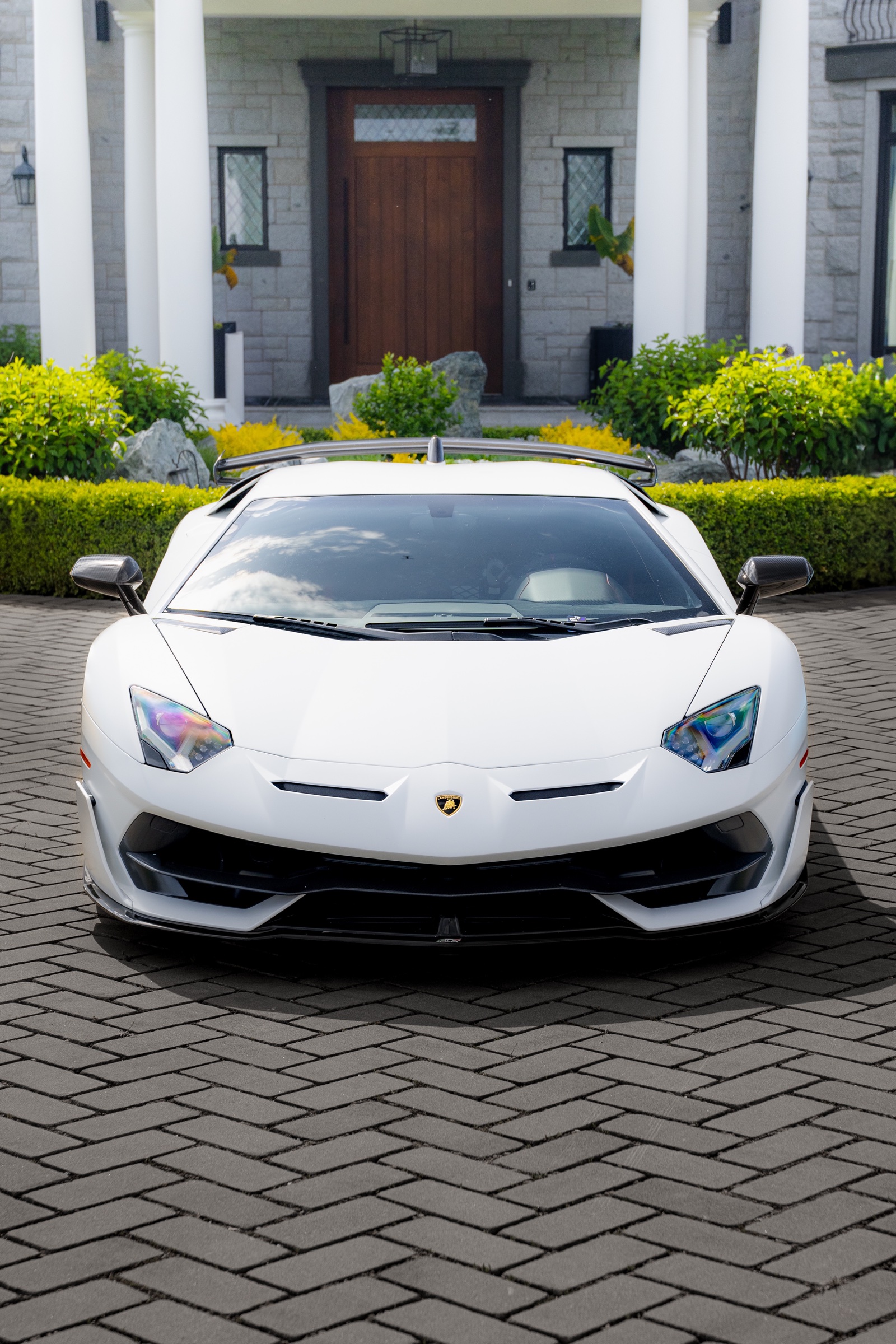 Front portrait of a white Lamborghini Aventador SVJ