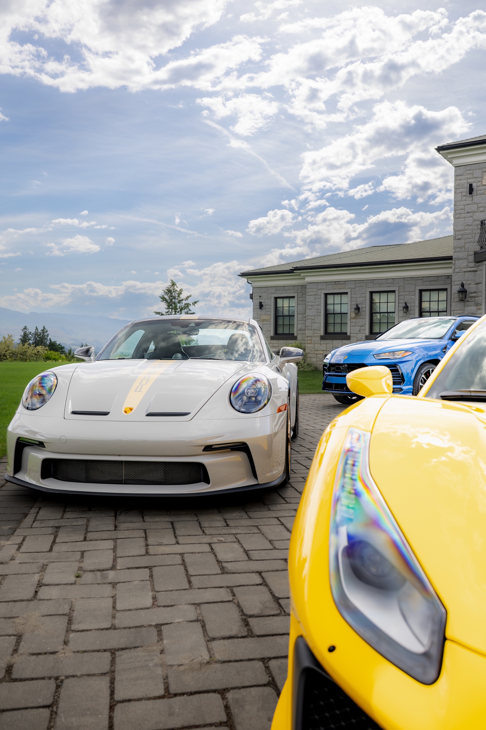 White Porsche 911 GT3 framed beside a yellow Ferrari 488 Pista