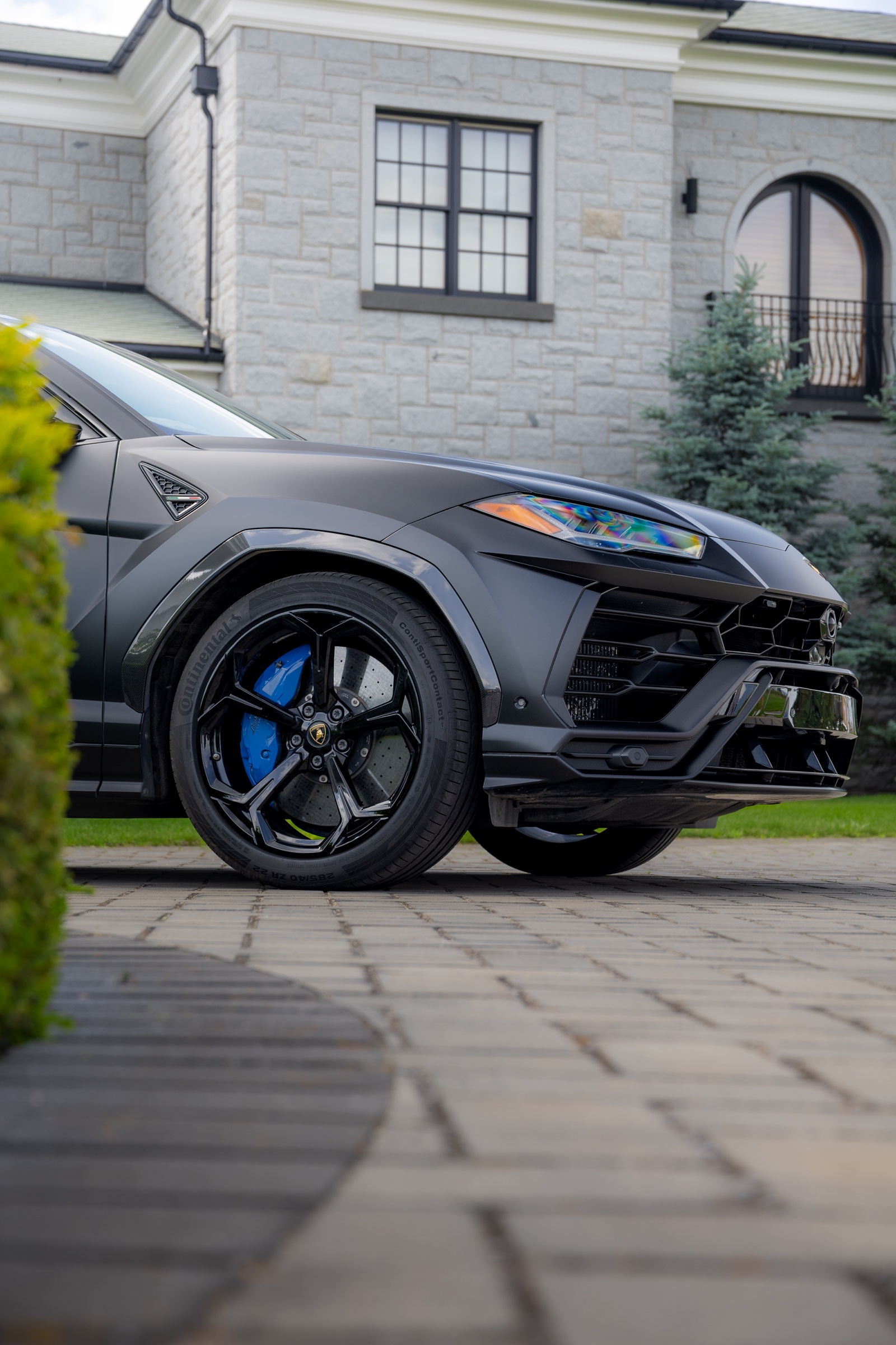 Matte-black Lamborghini Urus wheel and front bodywork detail